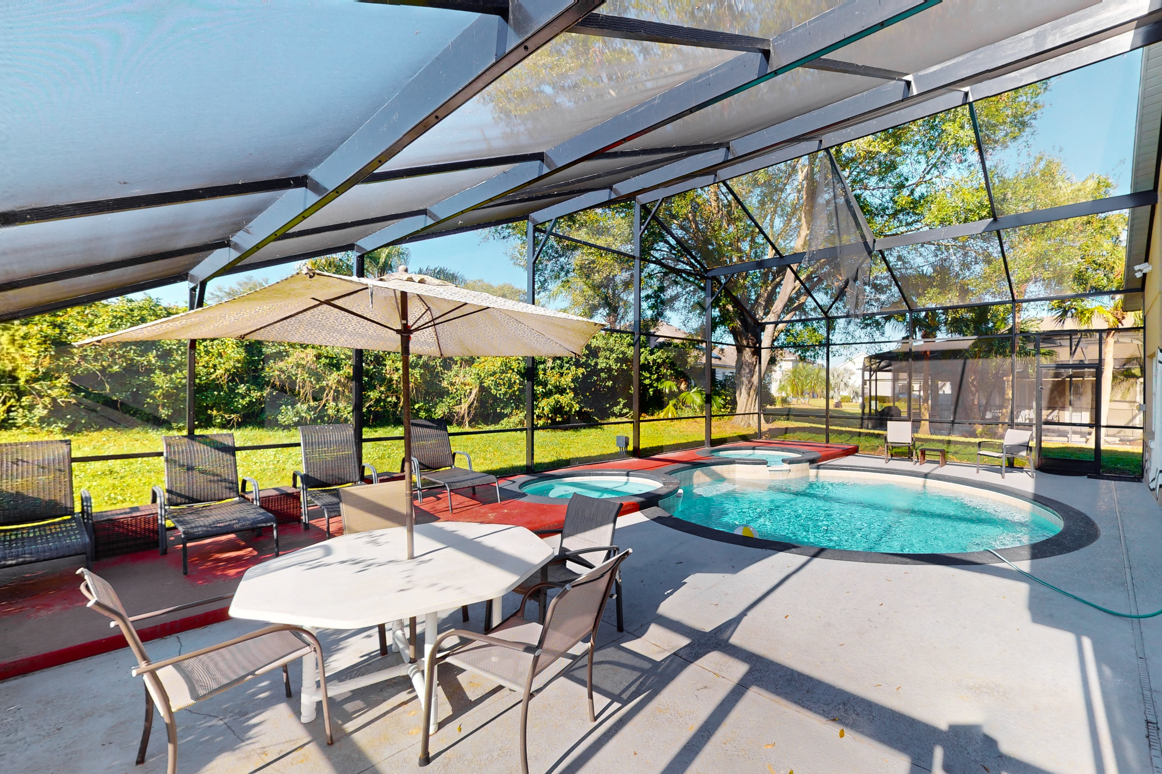 Spacious home with game room and mickey shaped pool and gas grill