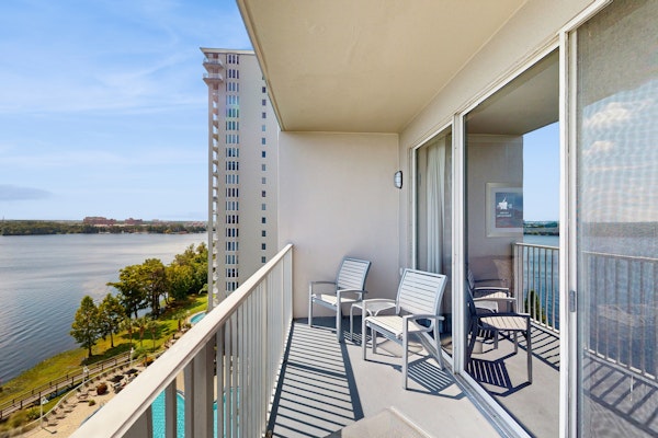 Unwind in a lakefront condo with AC, pool, hot tub & fitness center close to fun