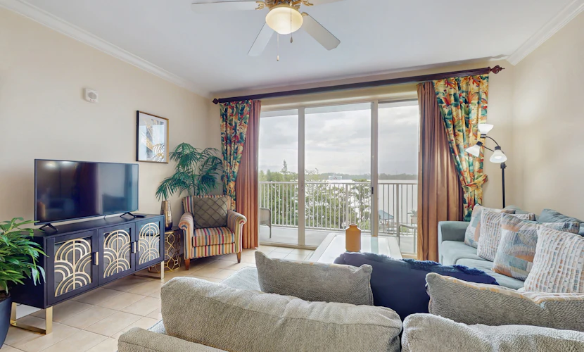 Lake-view 3rd-floor condo with hot tub, pools, balcony, shuttle service, & gyms