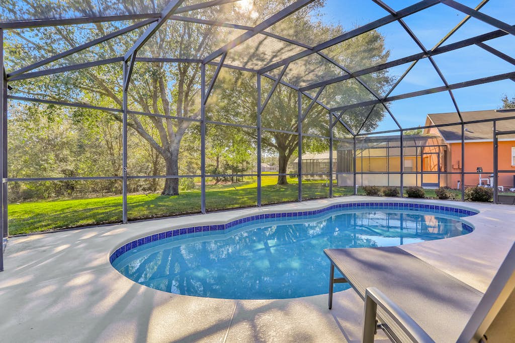 Peaceful home with an enclosed patio, pool, grill, washer/dryer, & AC