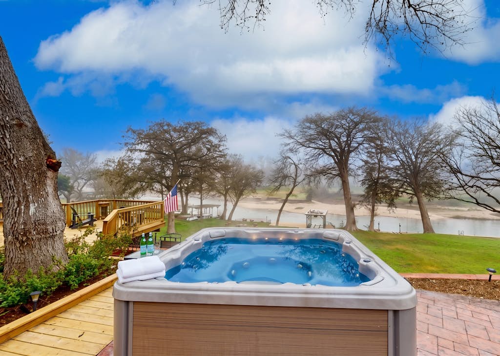 Idyllic waterfront getaway with private hot tub & deck views - near golf