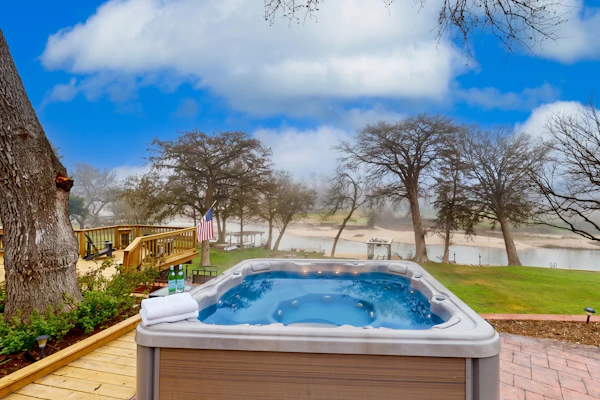 Idyllic waterfront getaway with private hot tub & deck views - near golf
