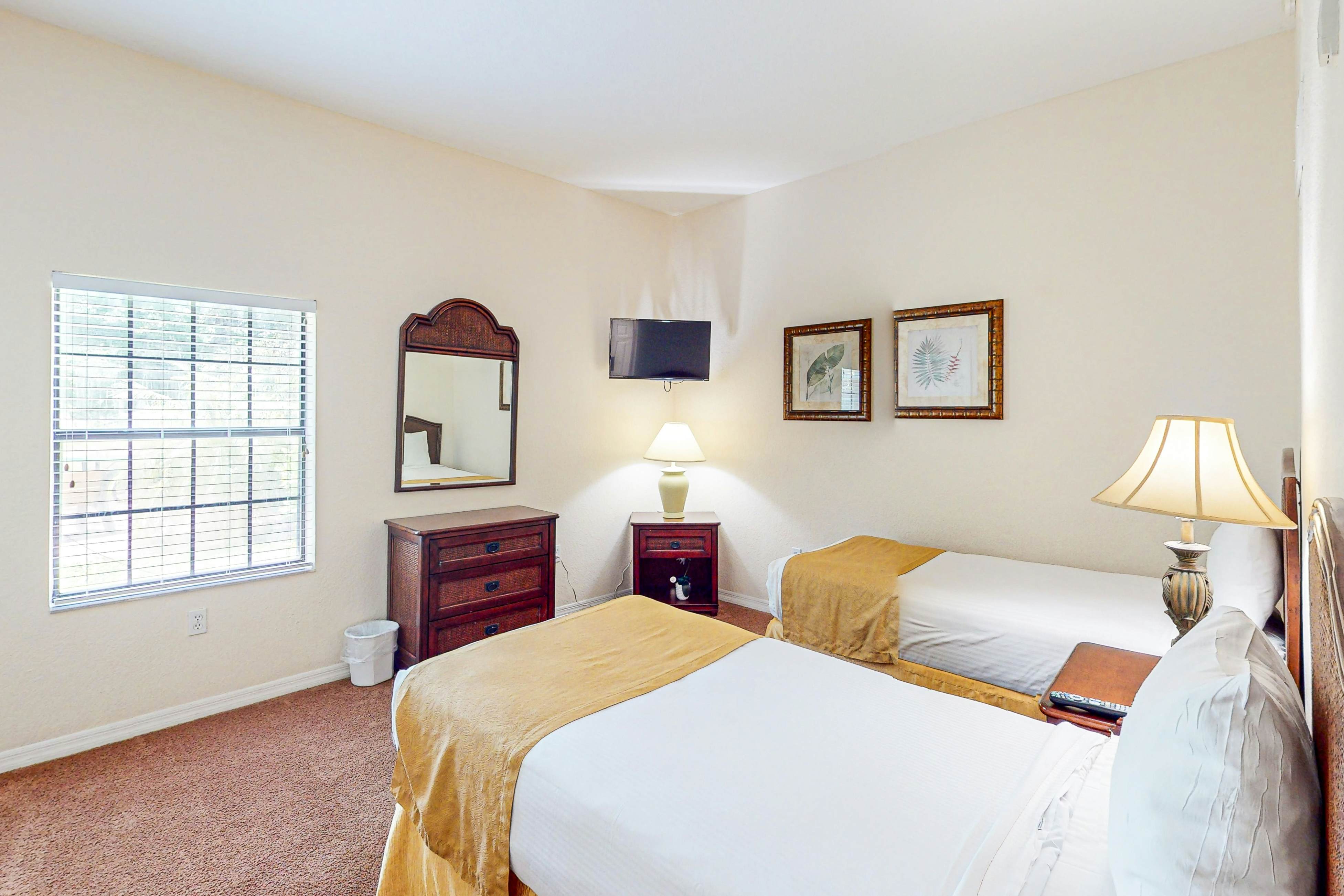 First-floor condo with shared pools, limited-mobility access, sauna, gym, patio