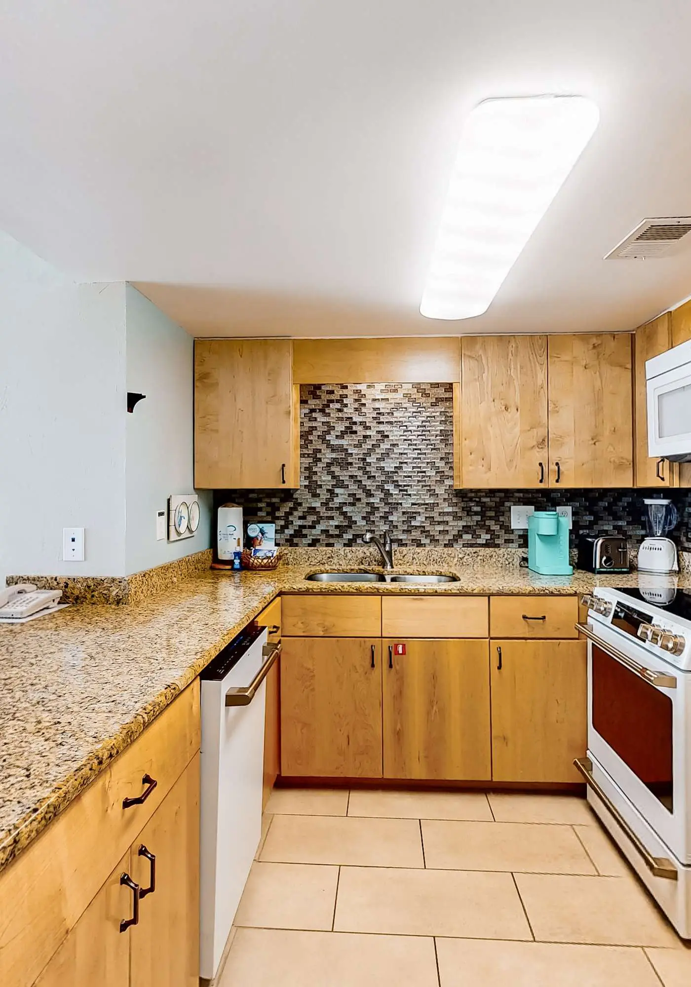 Gulf-front condo with balcony, pool, central AC, & grill