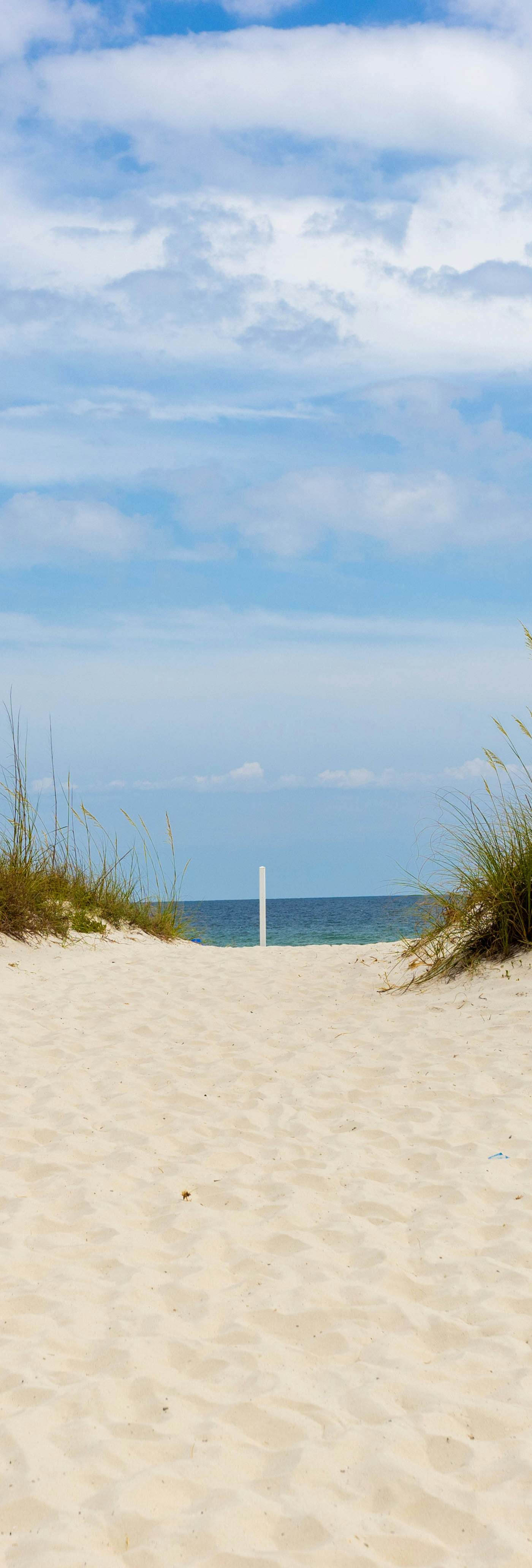 First-floor dog-friendly condo with on-site pool, beach access, & balcony