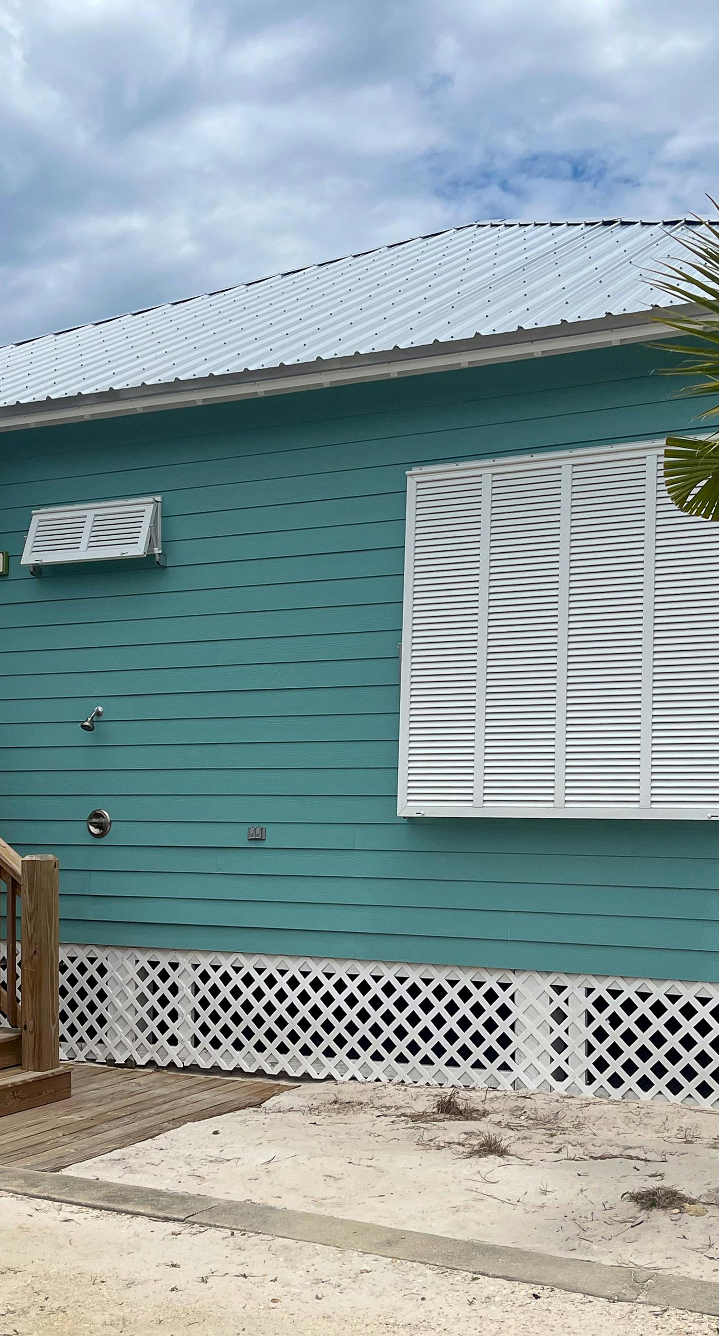 Modern beach home with screened porch, on-site pool, AC, & W&D