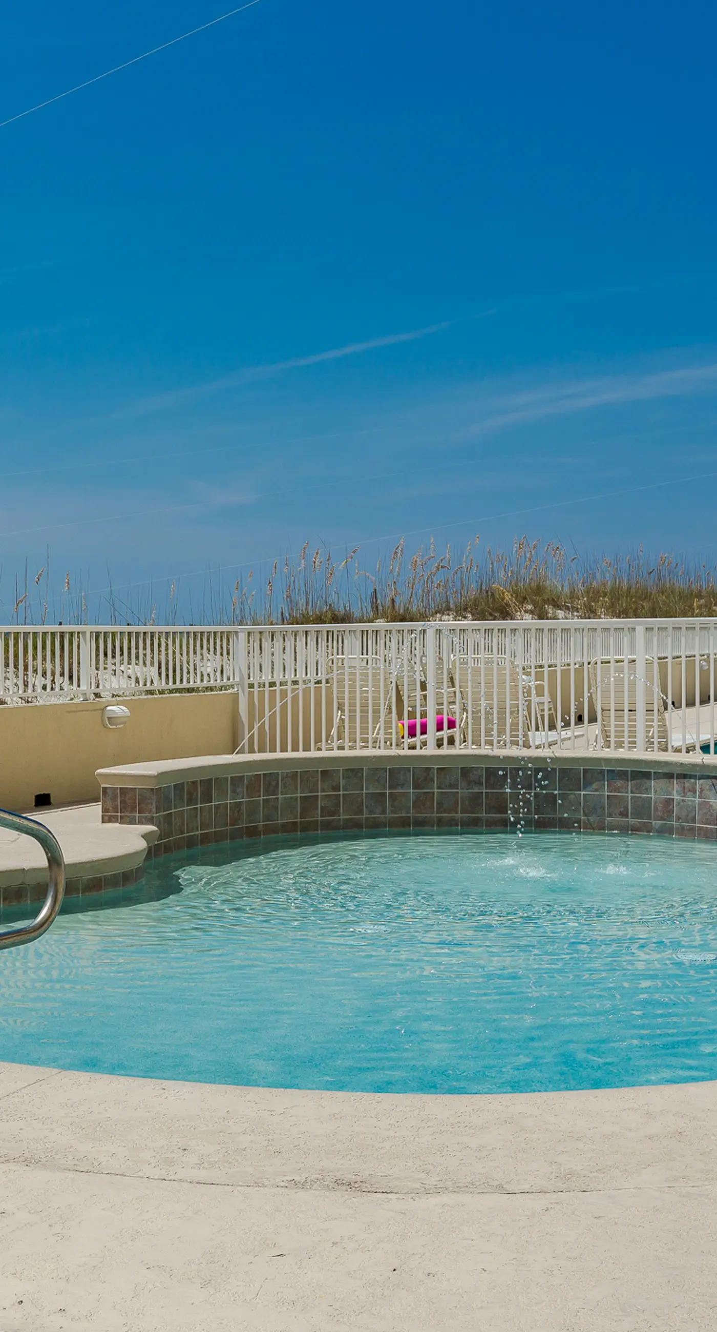 Beachfront condo w/ private, corner balcony, community pools, & a grilling area