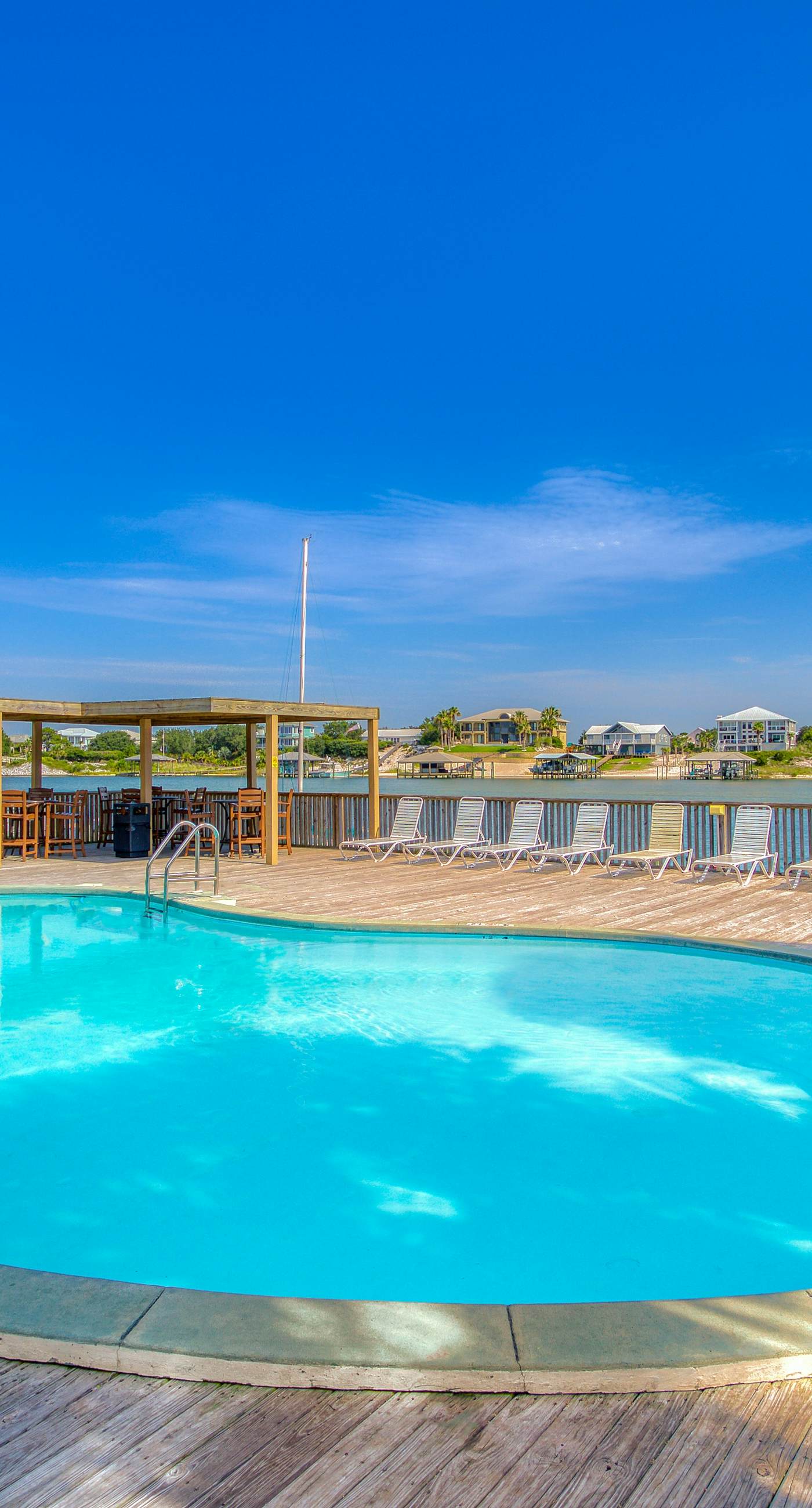 Riverside condo with pool, covered balcony, & easy beach access