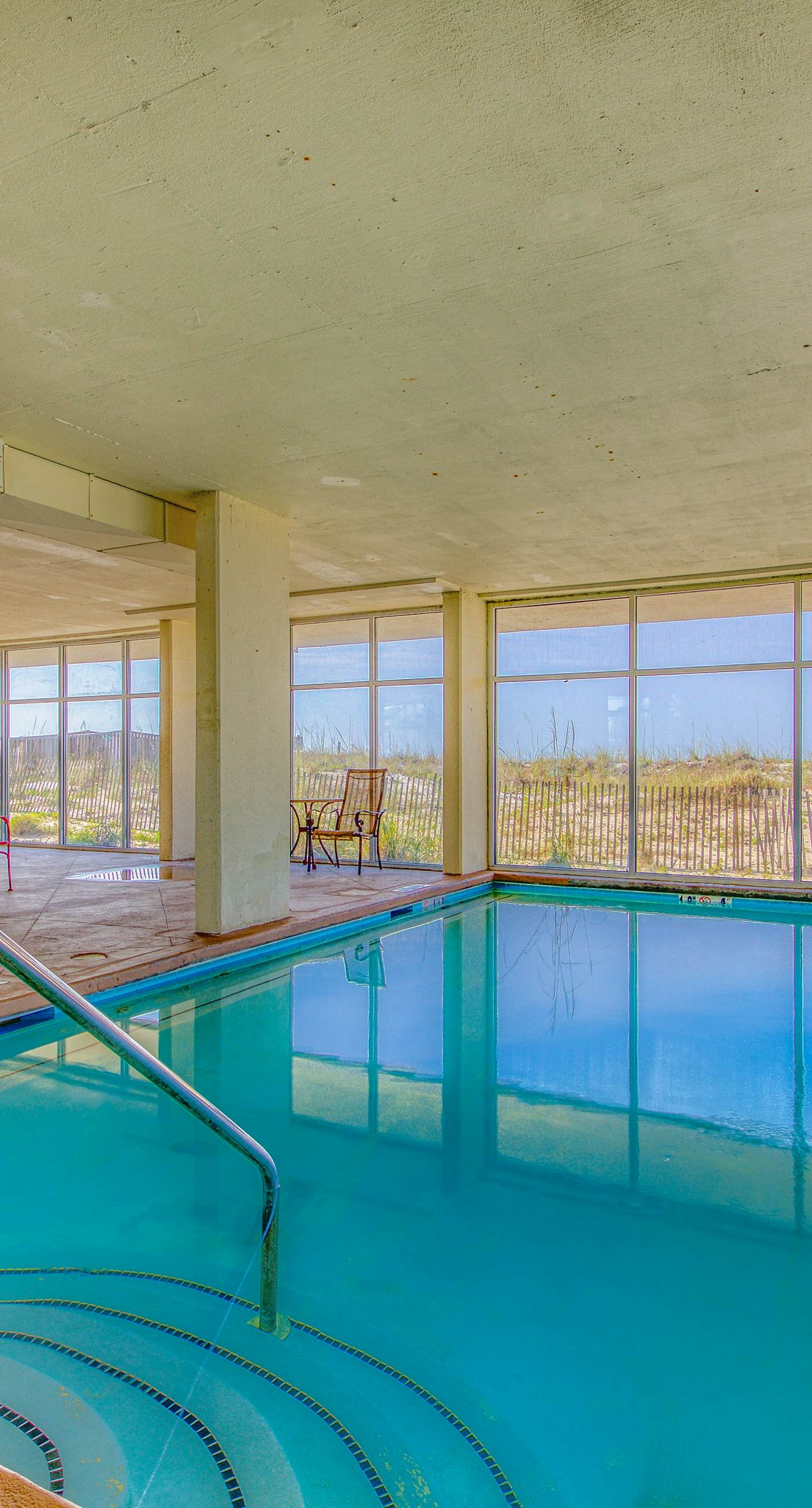 Riverside condo with pool, covered balcony, & easy beach access