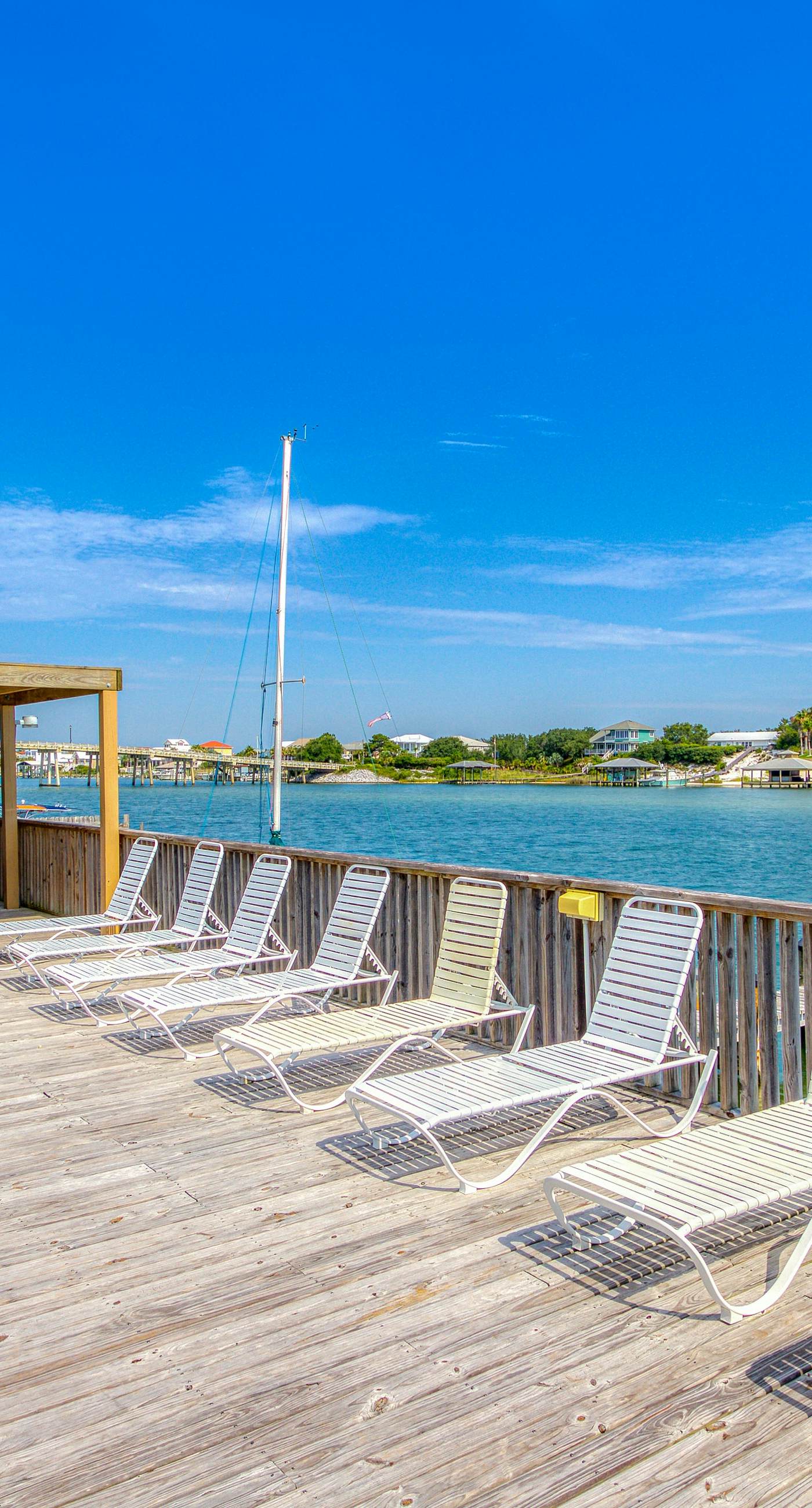 Riverside condo with pool, covered balcony, & easy beach access