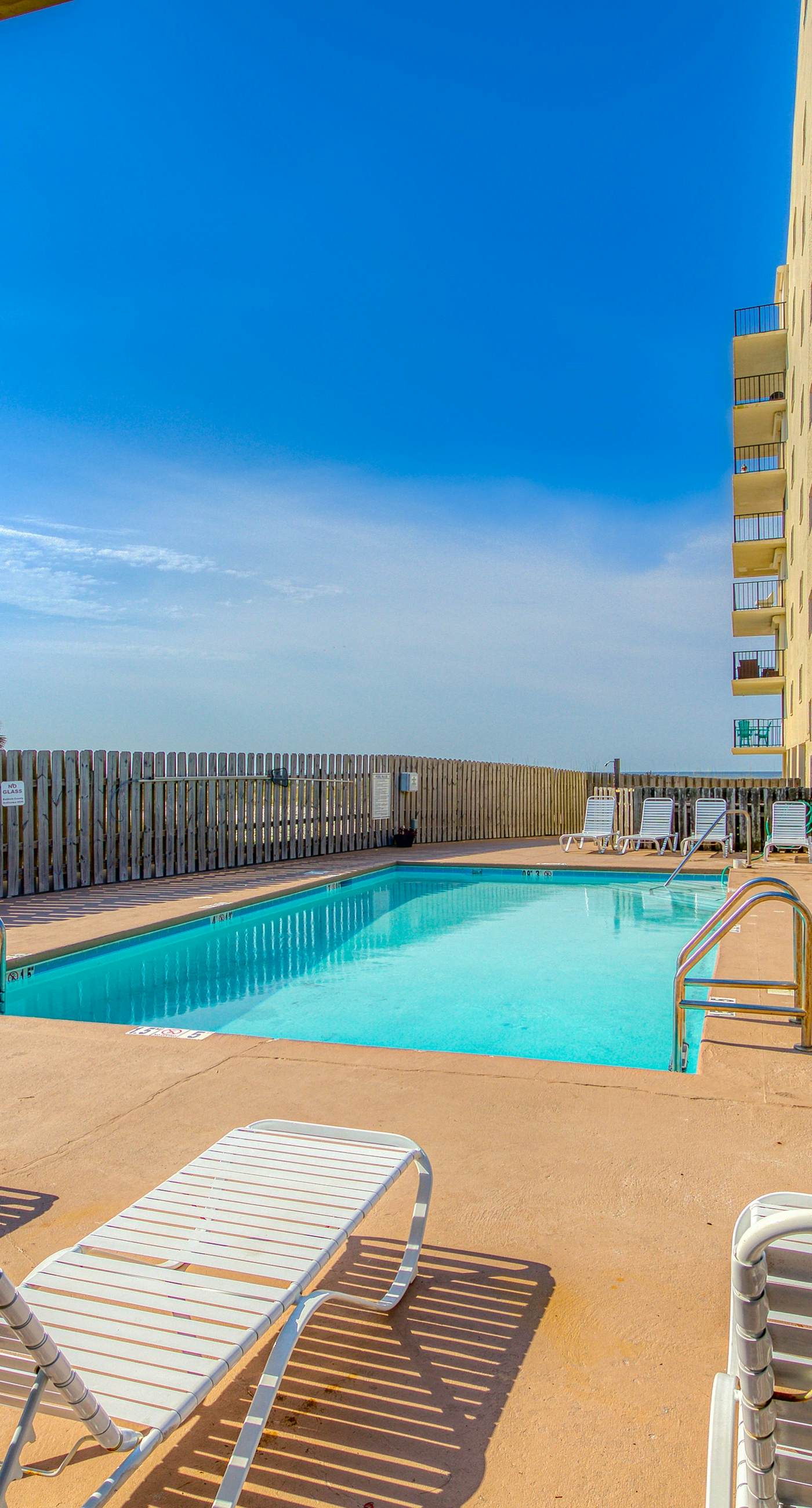 Riverside condo with pool, covered balcony, & easy beach access