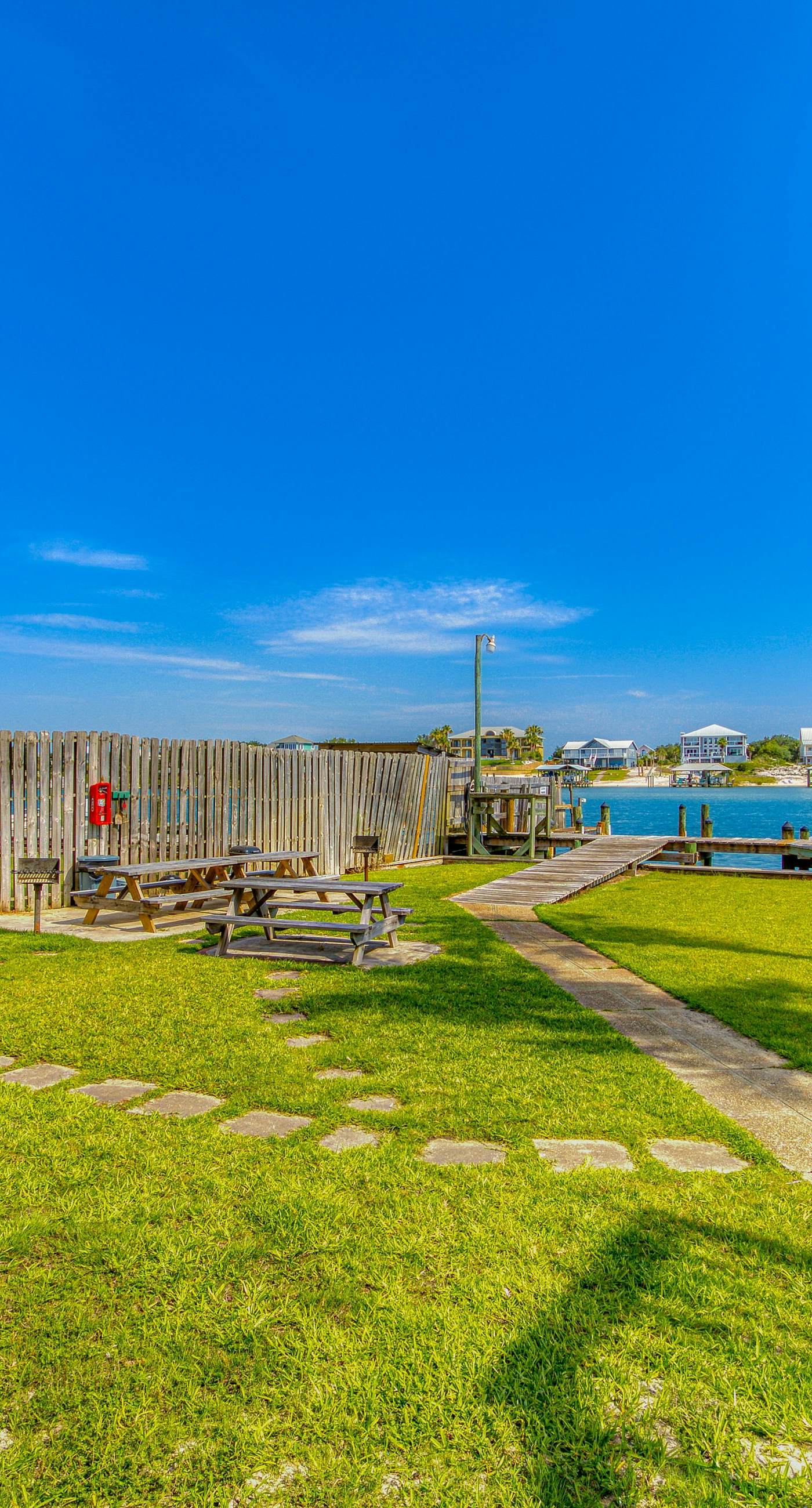 Riverside condo with pool, covered balcony, & easy beach access