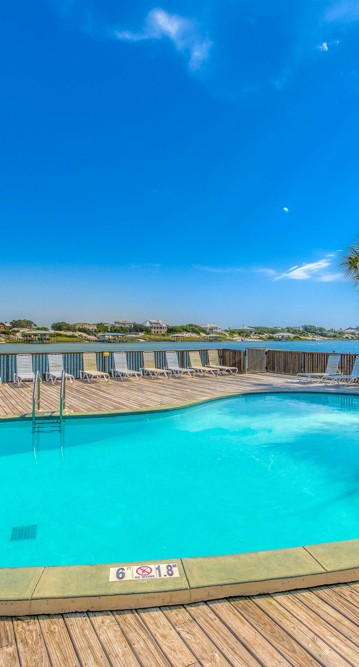 Riverside condo with pool, covered balcony, & easy beach access