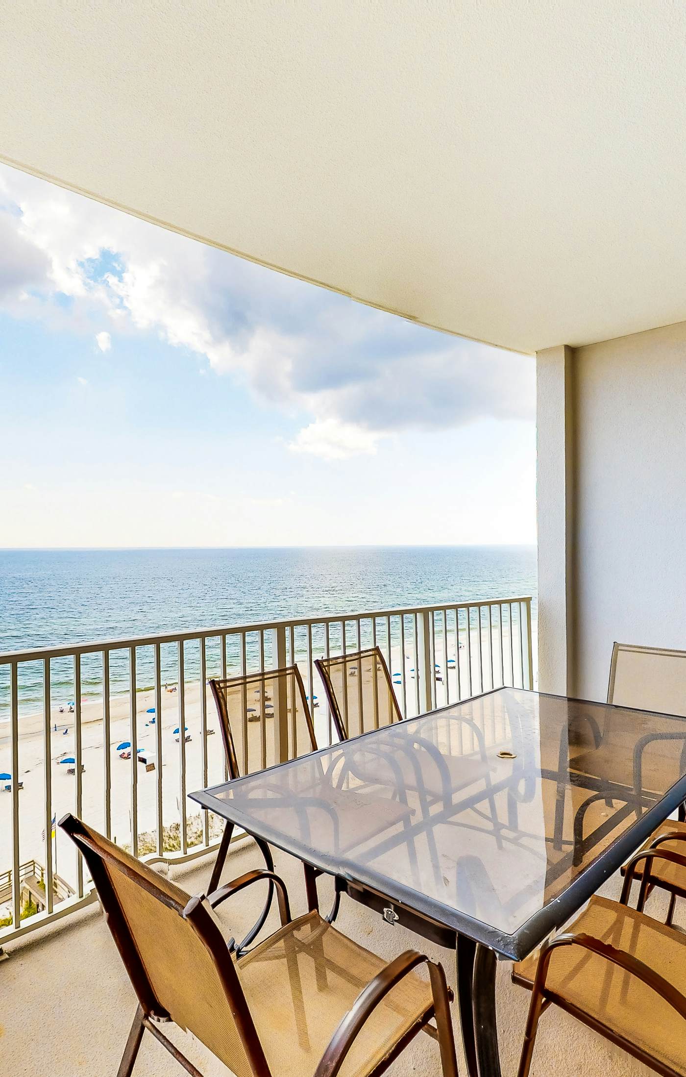 Gulf-front condo with shaded balcony, pools, hot tubs, gym & beach access
