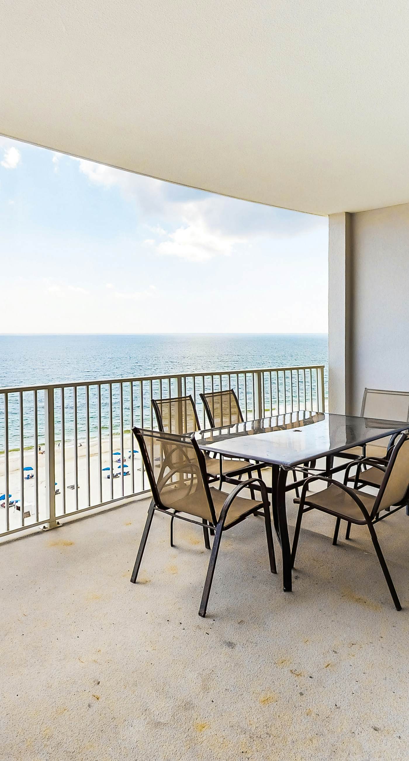 Gulf-front condo with shaded balcony, pools, hot tubs, gym & beach access