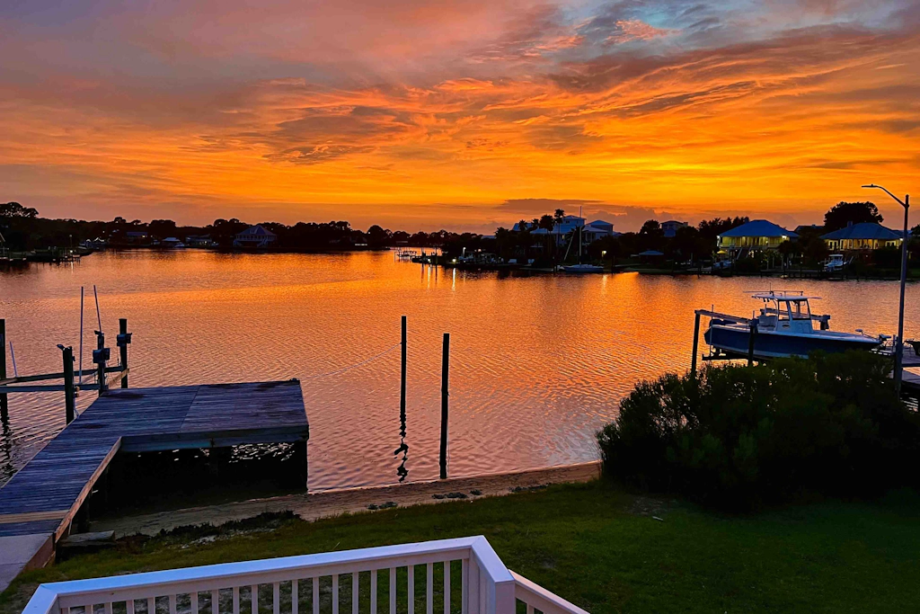 Inviting waterfront home with balcony, full kitchen, central AC, & W/D