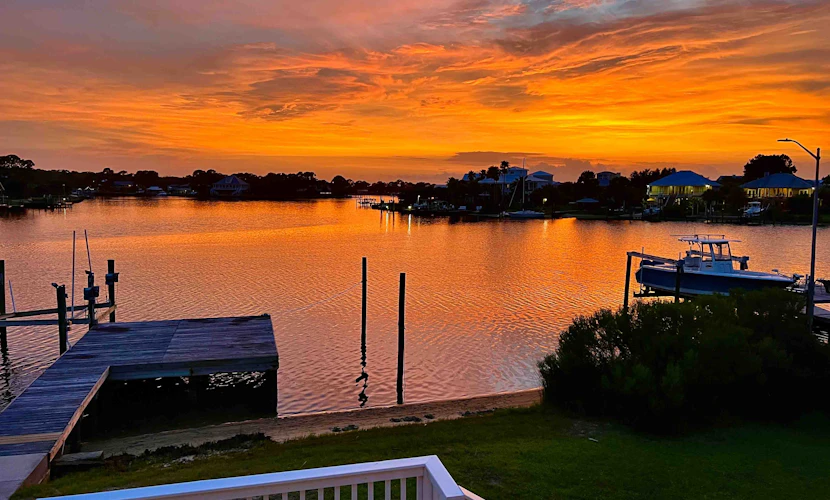 Inviting waterfront home with balcony, full kitchen, central AC, & W/D