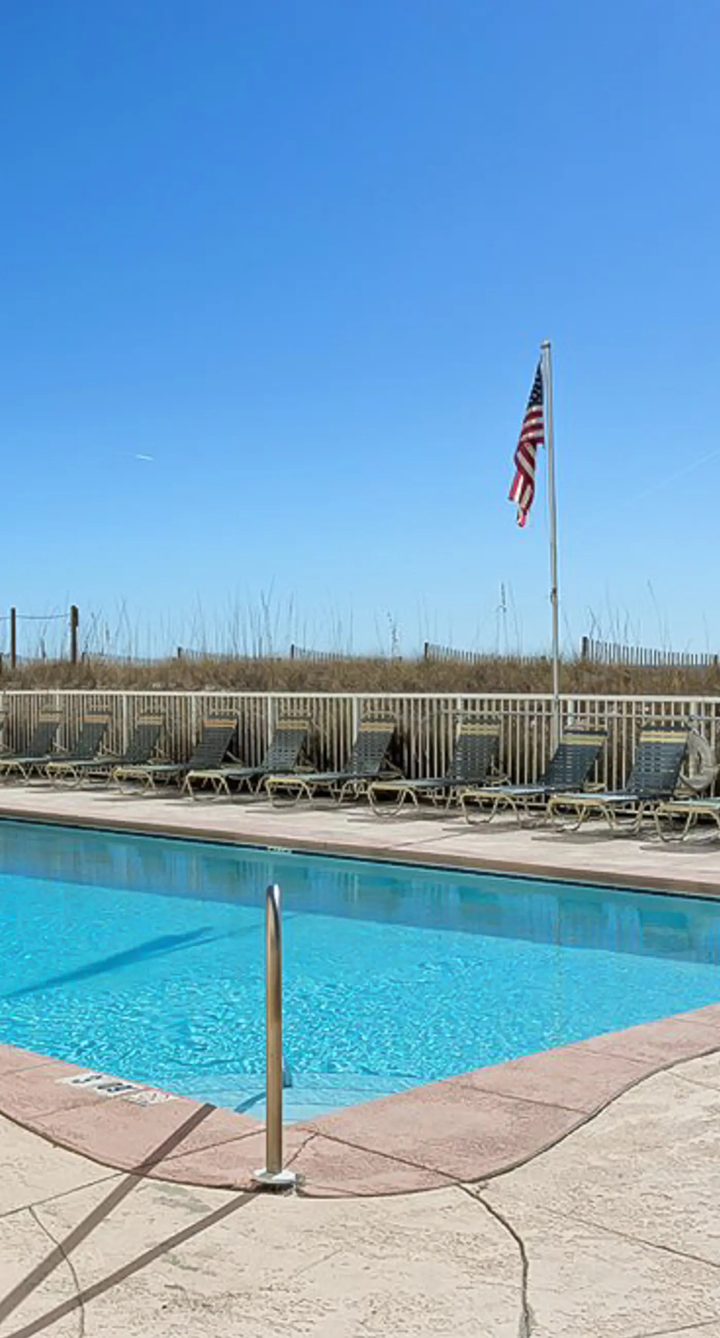 Beachfront condo with enclosed balcony, pool, views, central AC, & grill