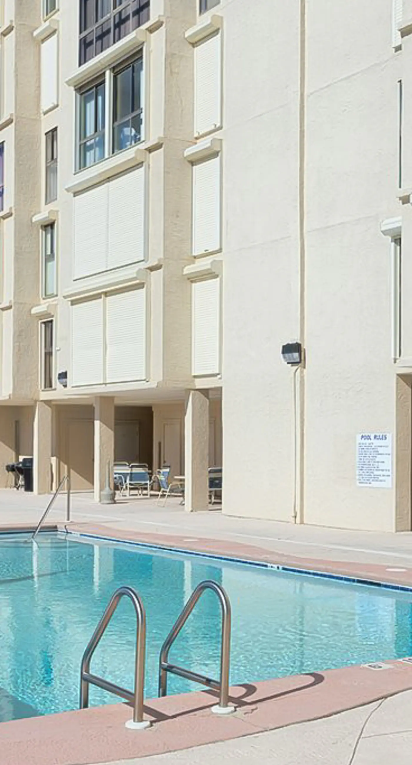 Beachfront condo with enclosed balcony, pool, views, central AC, & grill