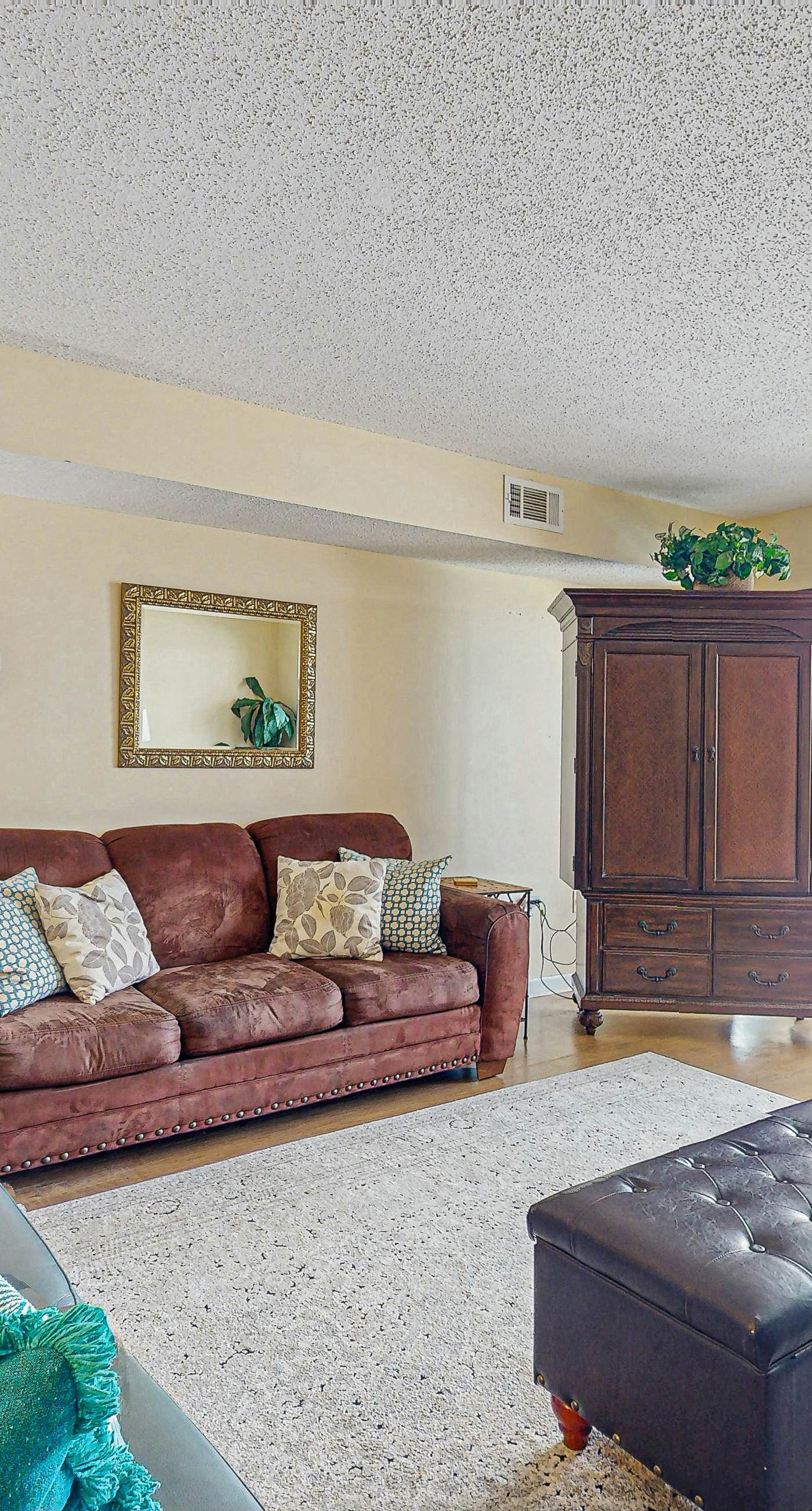 Beachfront condo with enclosed balcony, pool, views, central AC, & grill