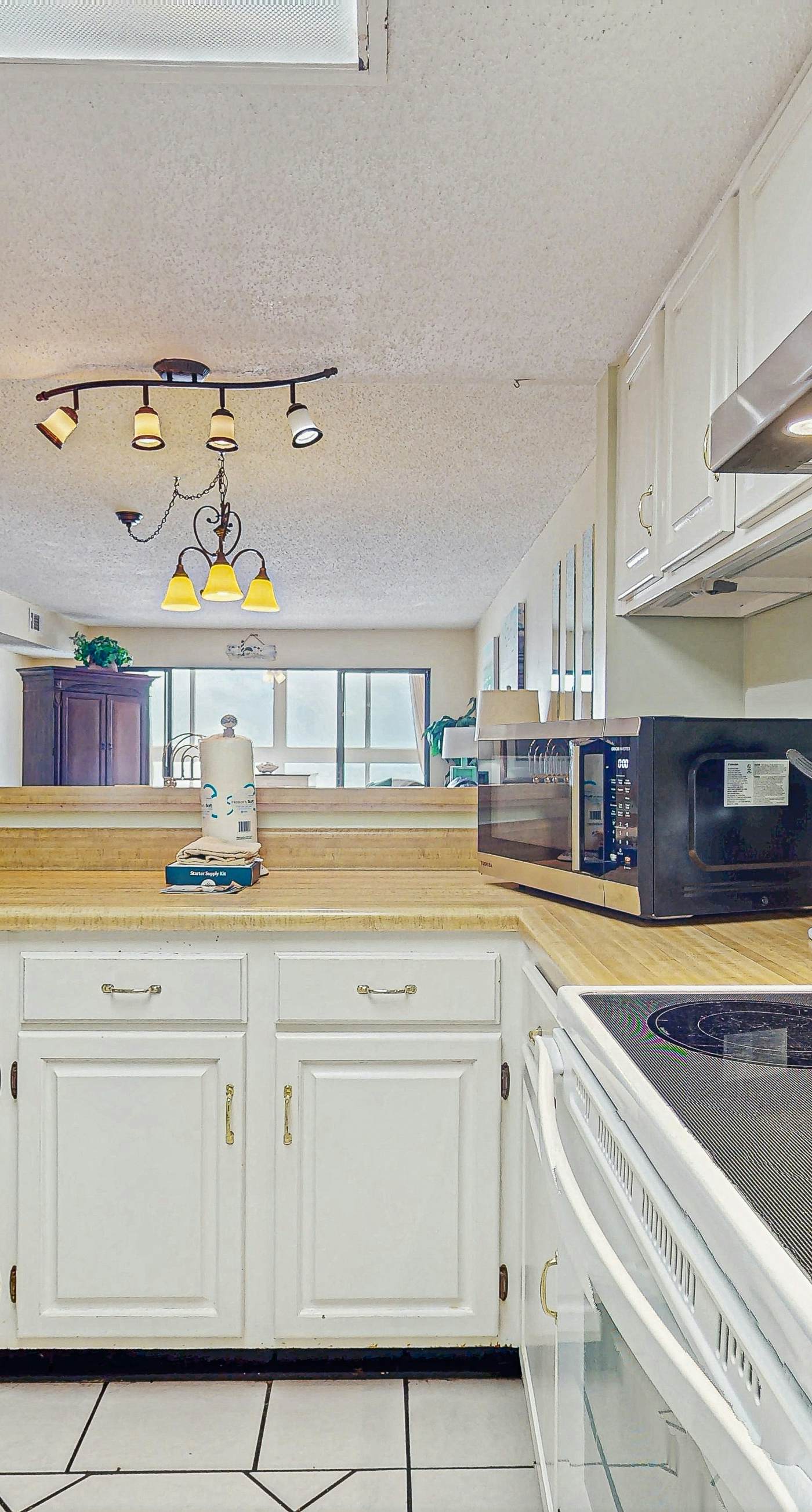 Beachfront condo with enclosed balcony, pool, views, central AC, & grill