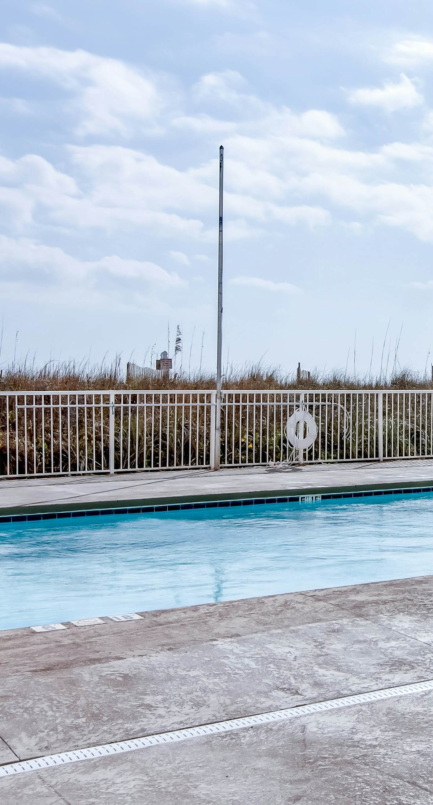 Beachfront condo with enclosed balcony, pool, views, central AC, & grill