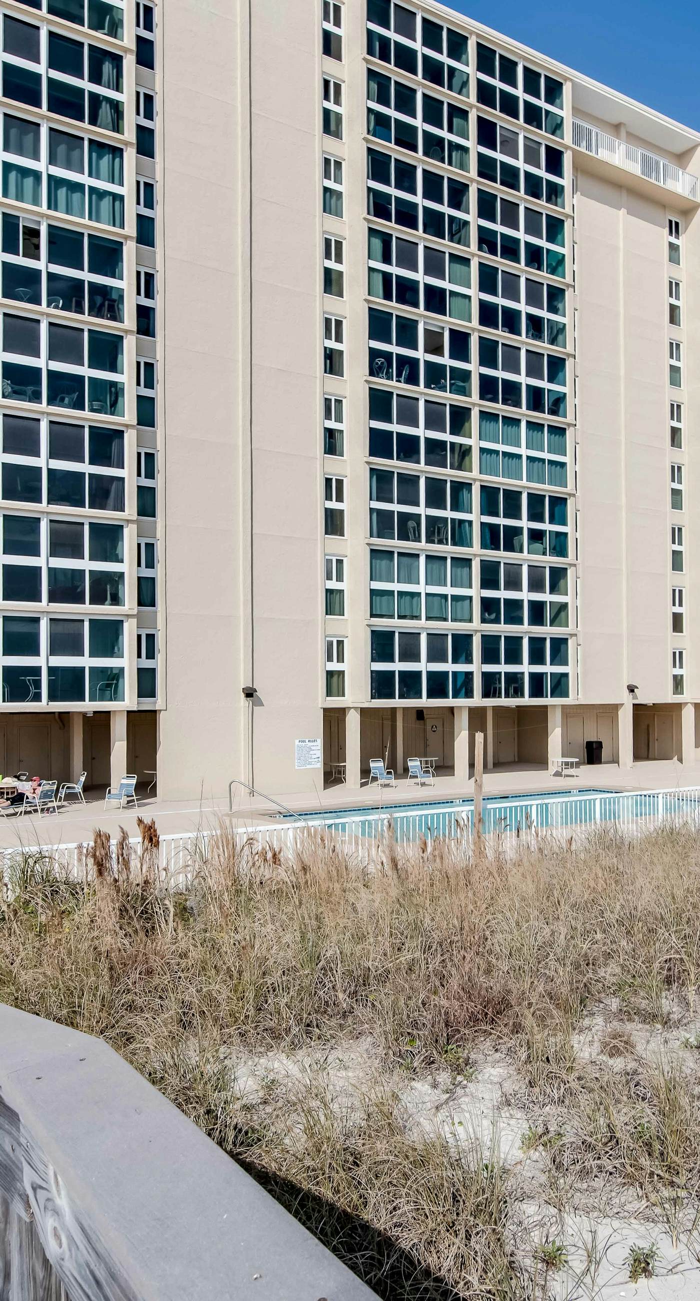 Beachfront condo with enclosed balcony, pool, views, central AC, & grill