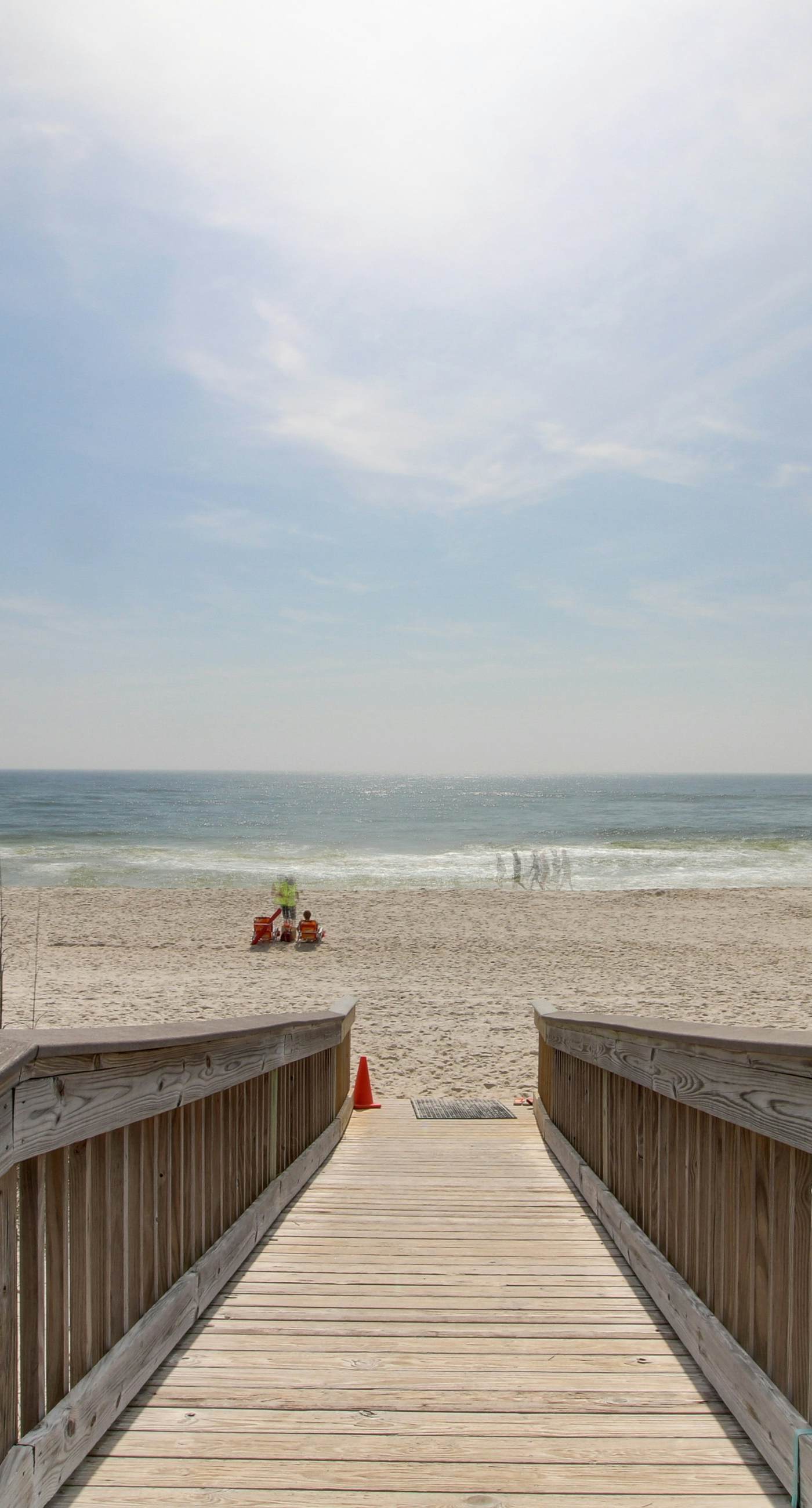 Beachfront condo with enclosed balcony, pool, views, central AC, & grill