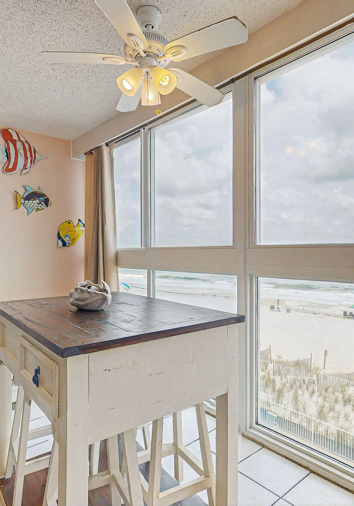 Beachfront condo with enclosed balcony, pool, views, central AC, & grill