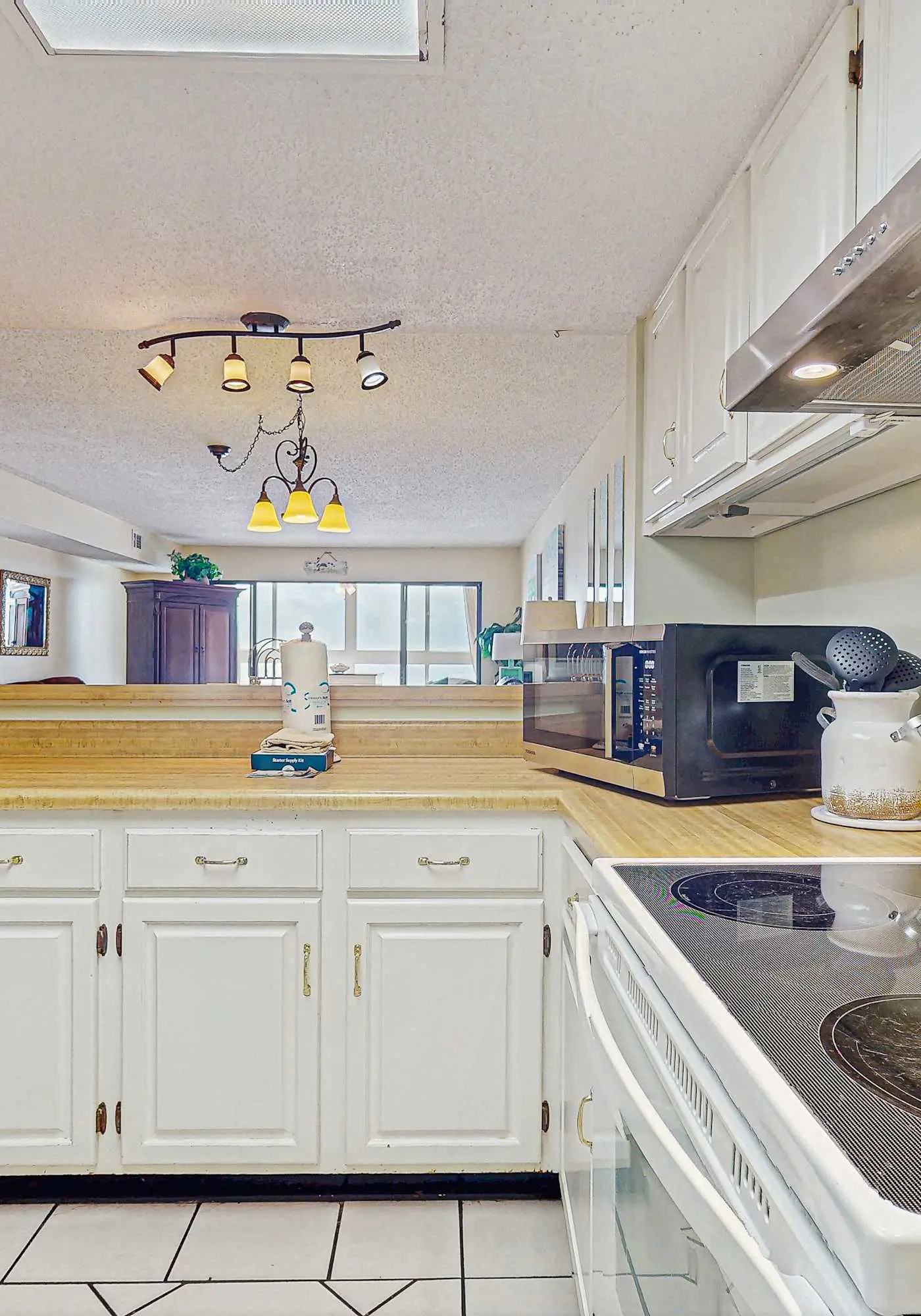 Beachfront condo with enclosed balcony, pool, views, central AC, & grill