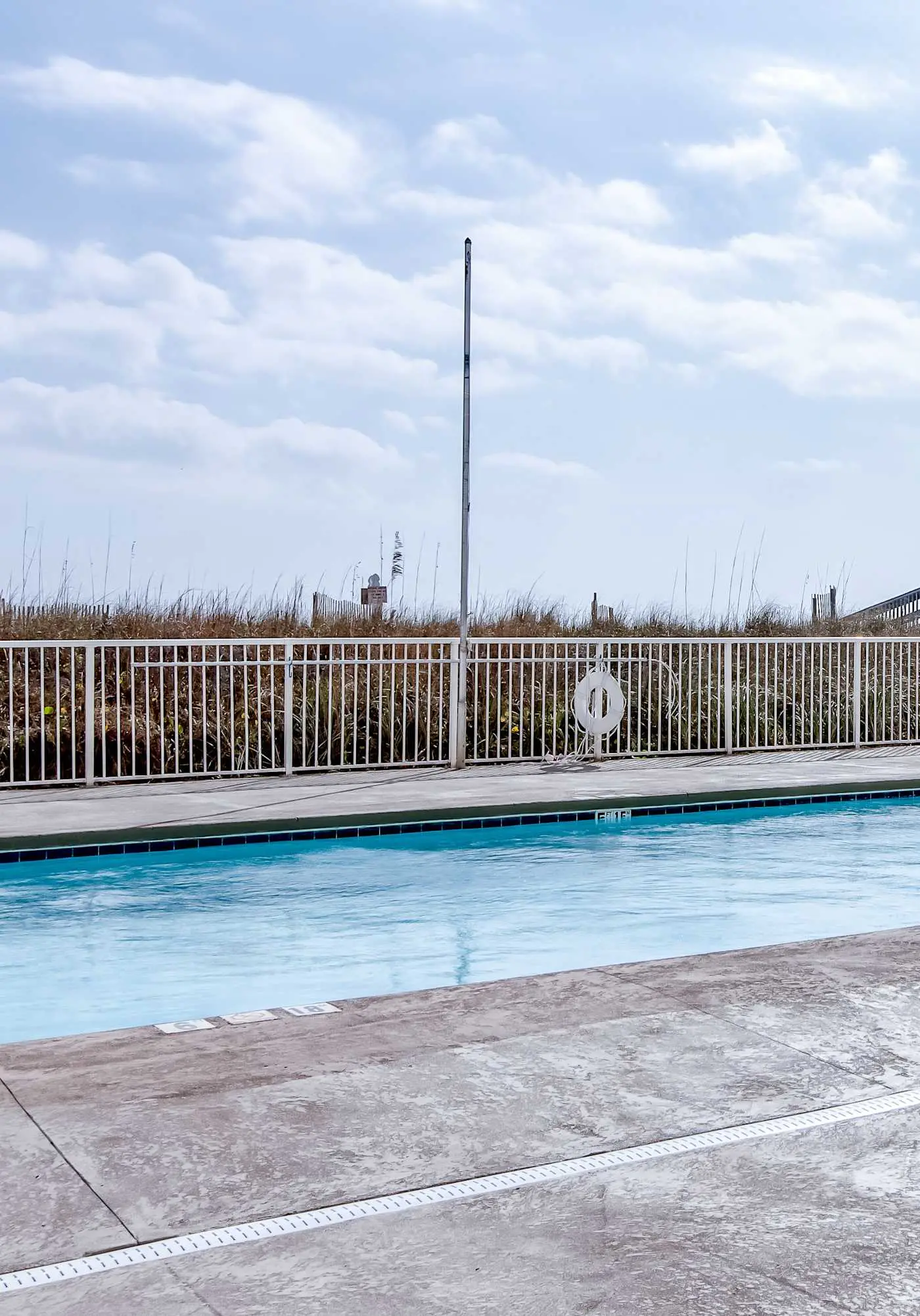 Beachfront condo with enclosed balcony, pool, views, central AC, & grill