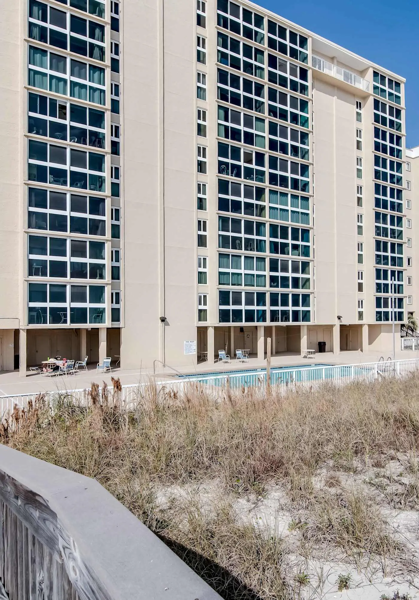 Beachfront condo with enclosed balcony, pool, views, central AC, & grill
