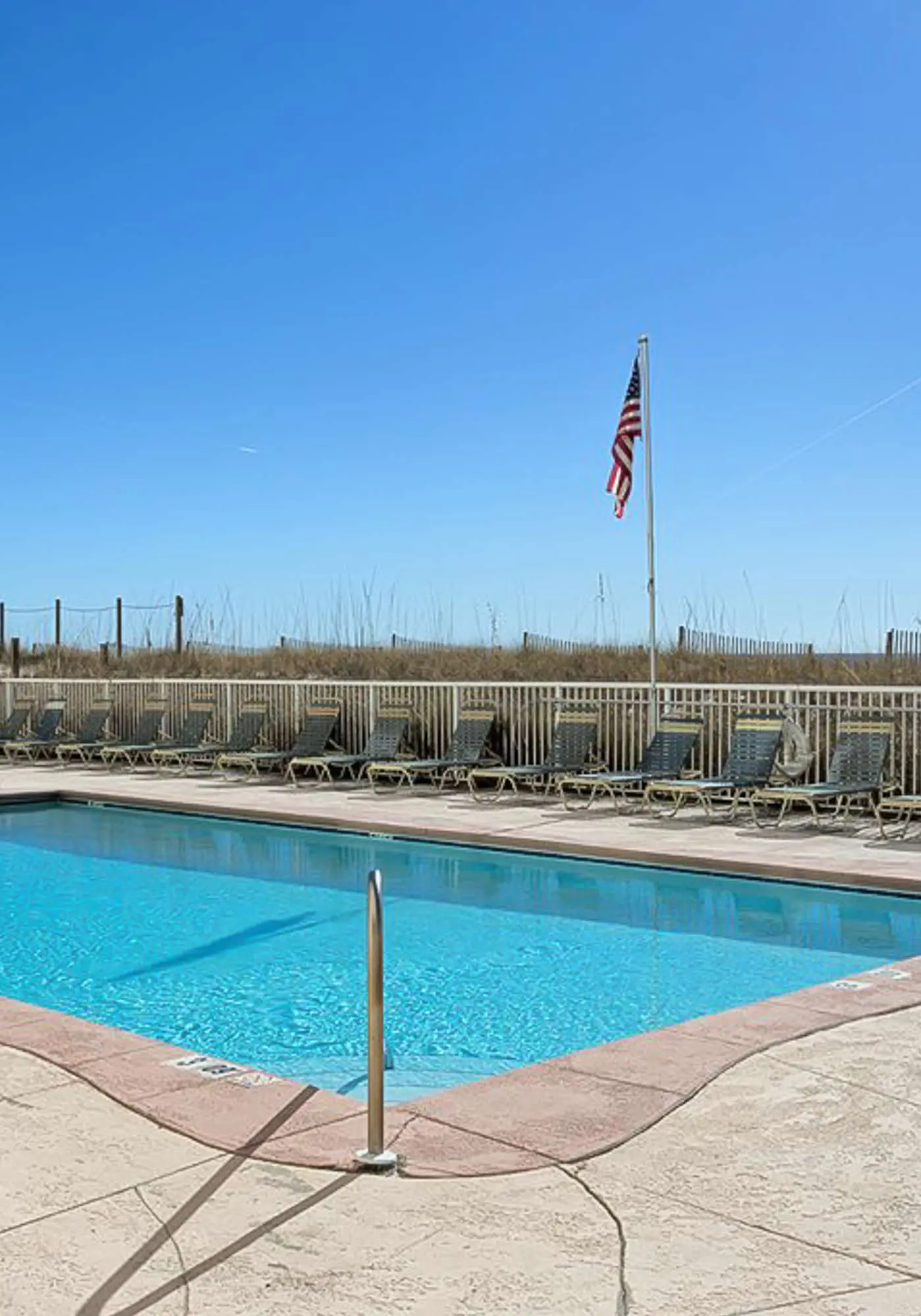 Beachfront condo with enclosed balcony, pool, views, central AC, & grill