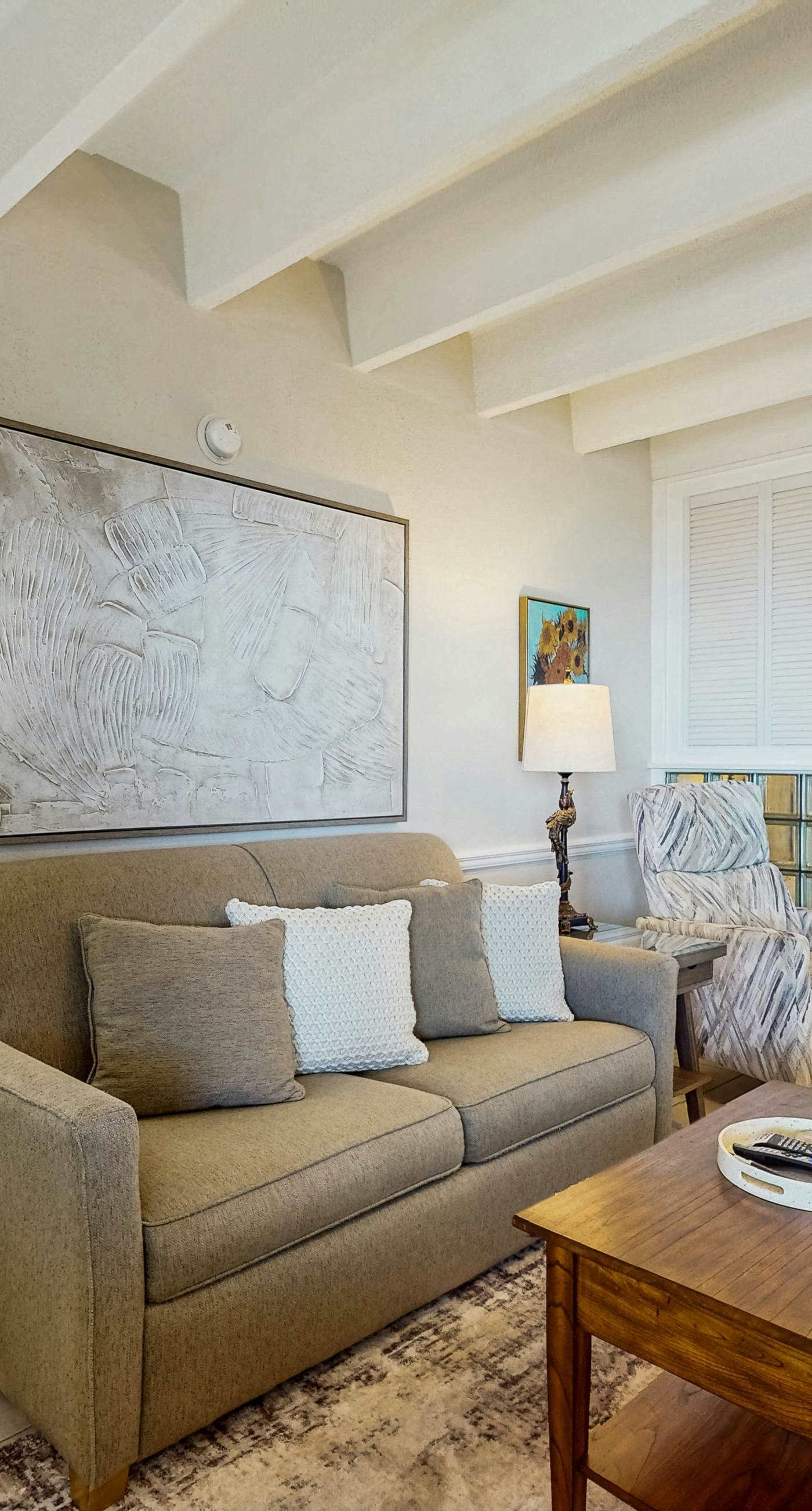 Ocean-view condo with pool access, outdoor seating, central AC & WiFi