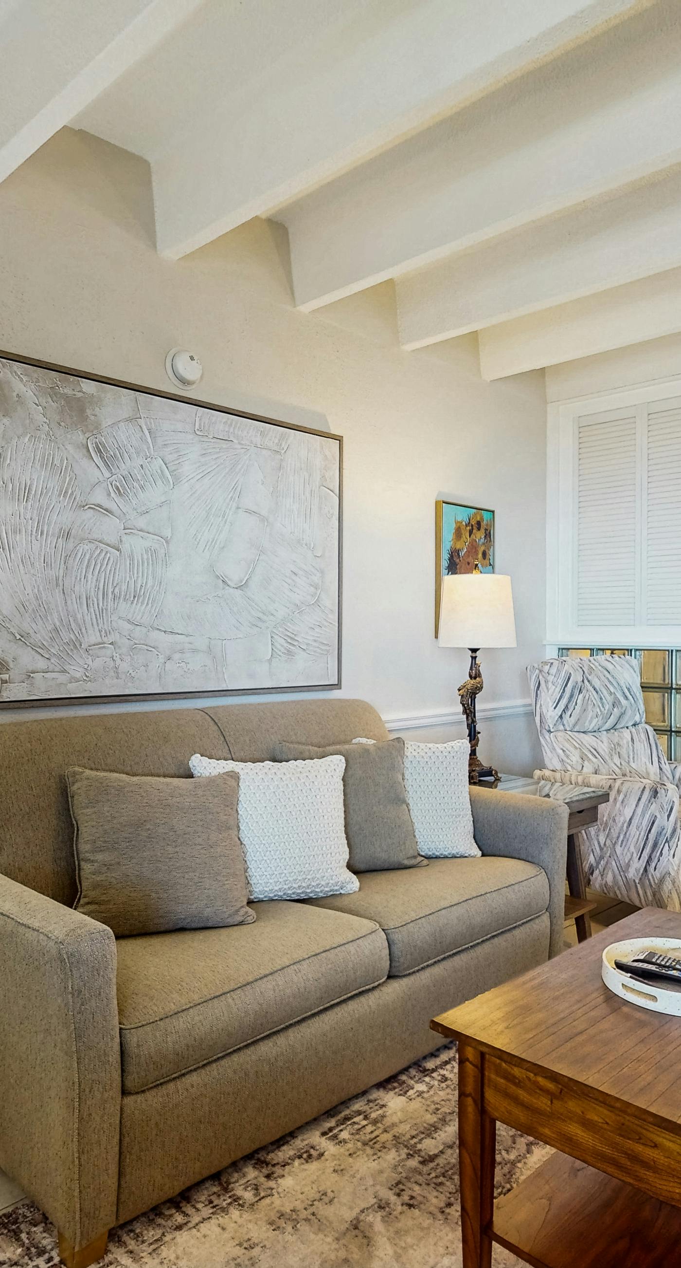 Ocean-view condo with pool access, outdoor seating, central AC & WiFi