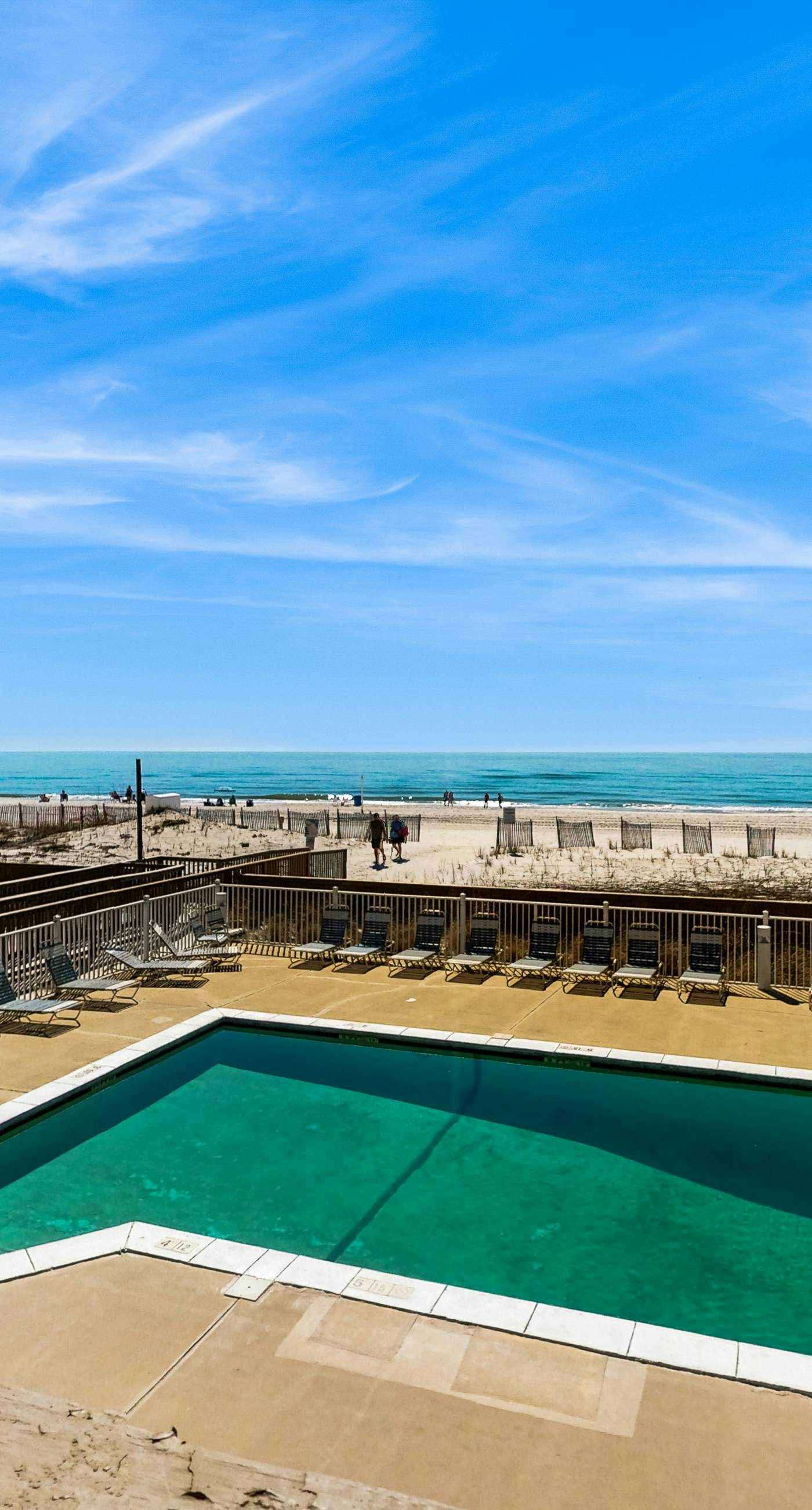 Ocean-view condo with pool access, outdoor seating, central AC & WiFi