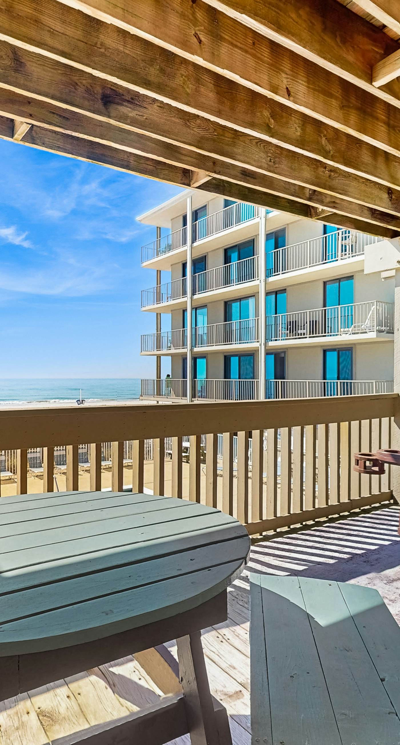 Ocean-view condo with pool access, outdoor seating, central AC & WiFi
