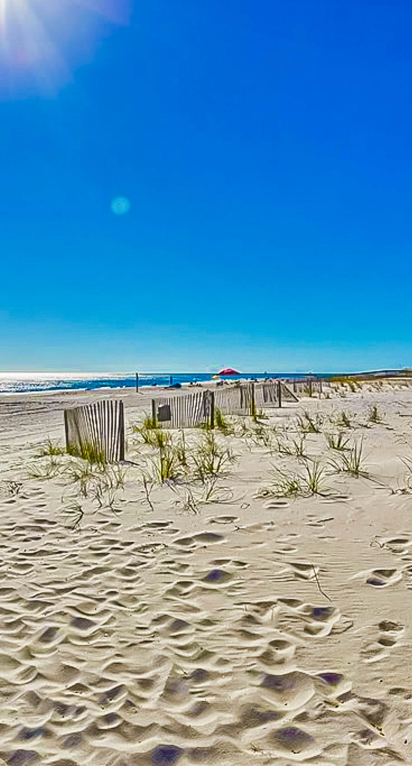 Ocean-view condo with pool access, outdoor seating, central AC & WiFi