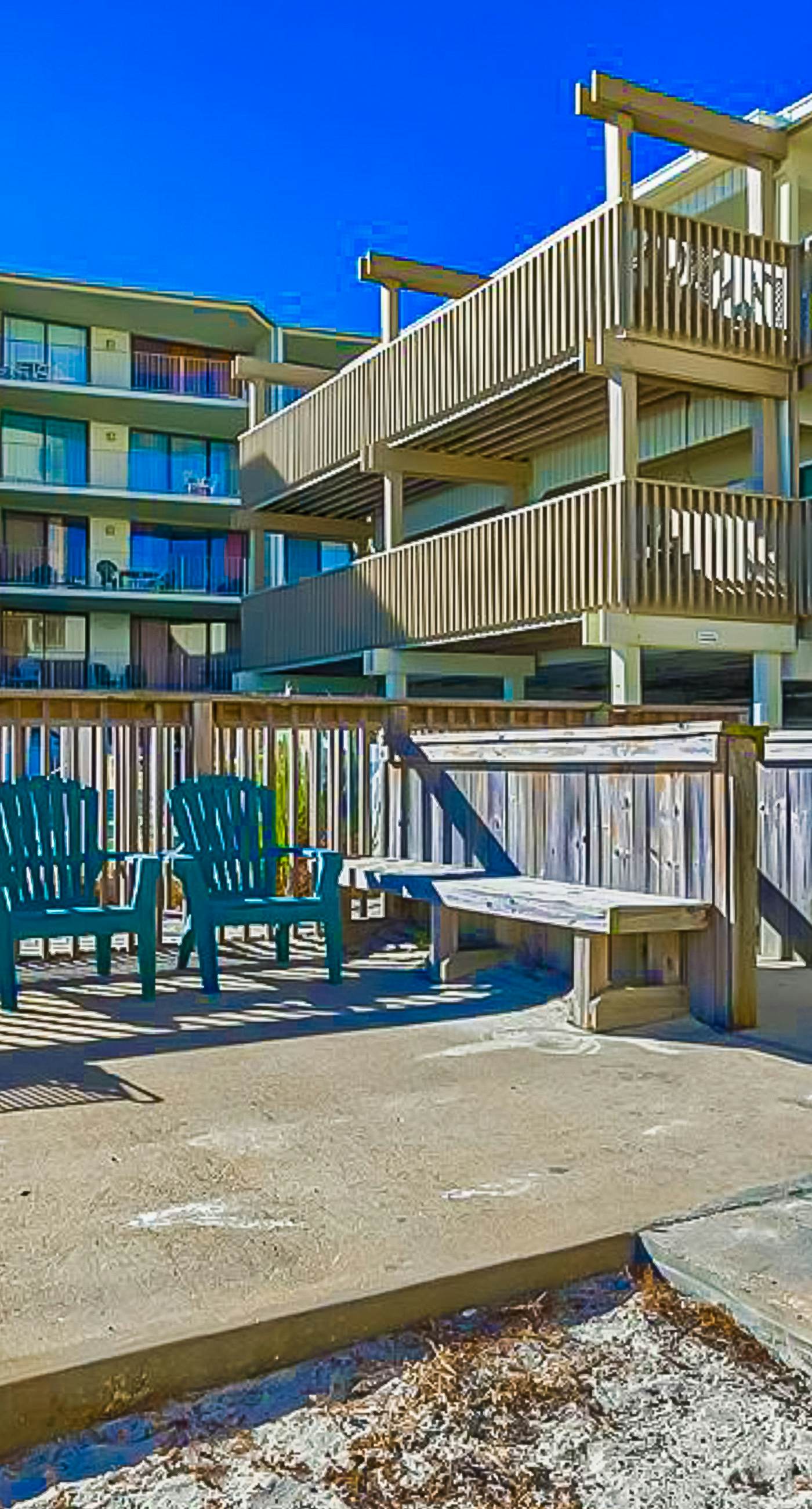Ocean-view condo with pool access, outdoor seating, central AC & WiFi
