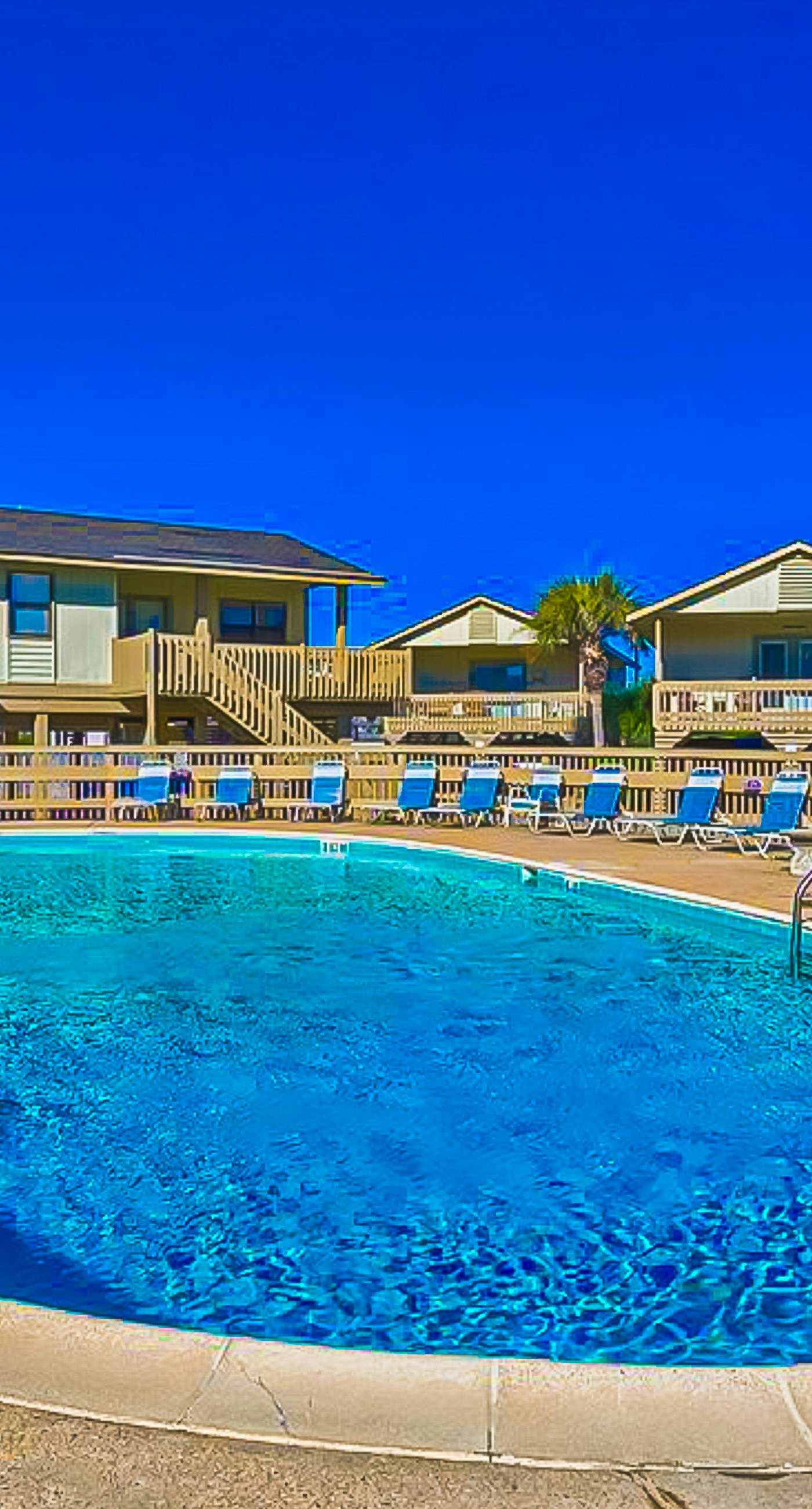 Ocean-view condo with pool access, outdoor seating, central AC & WiFi