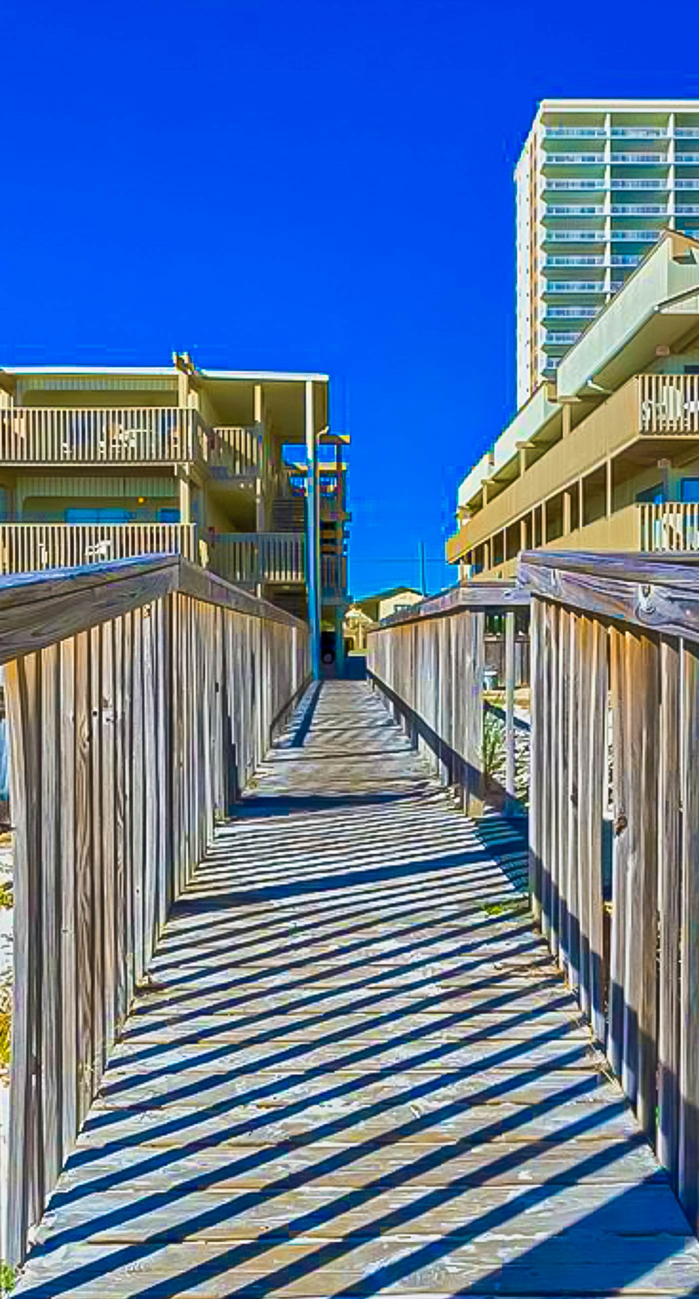 Ocean-view condo with pool access, outdoor seating, central AC & WiFi