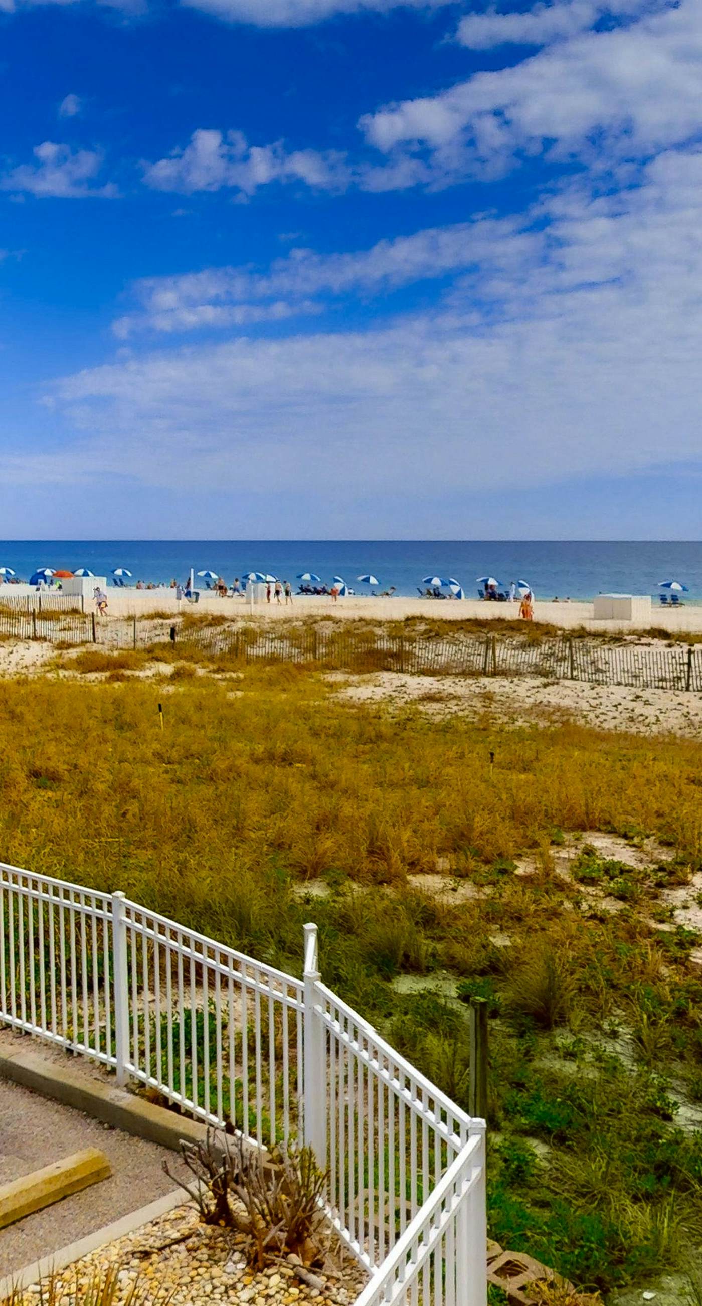 Convenient condo with balcony, beach views, pool, & central AC