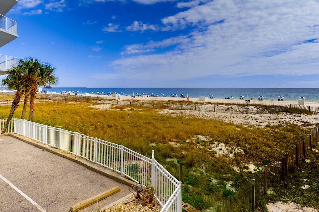 Convenient condo with balcony, beach views, pool, & central AC