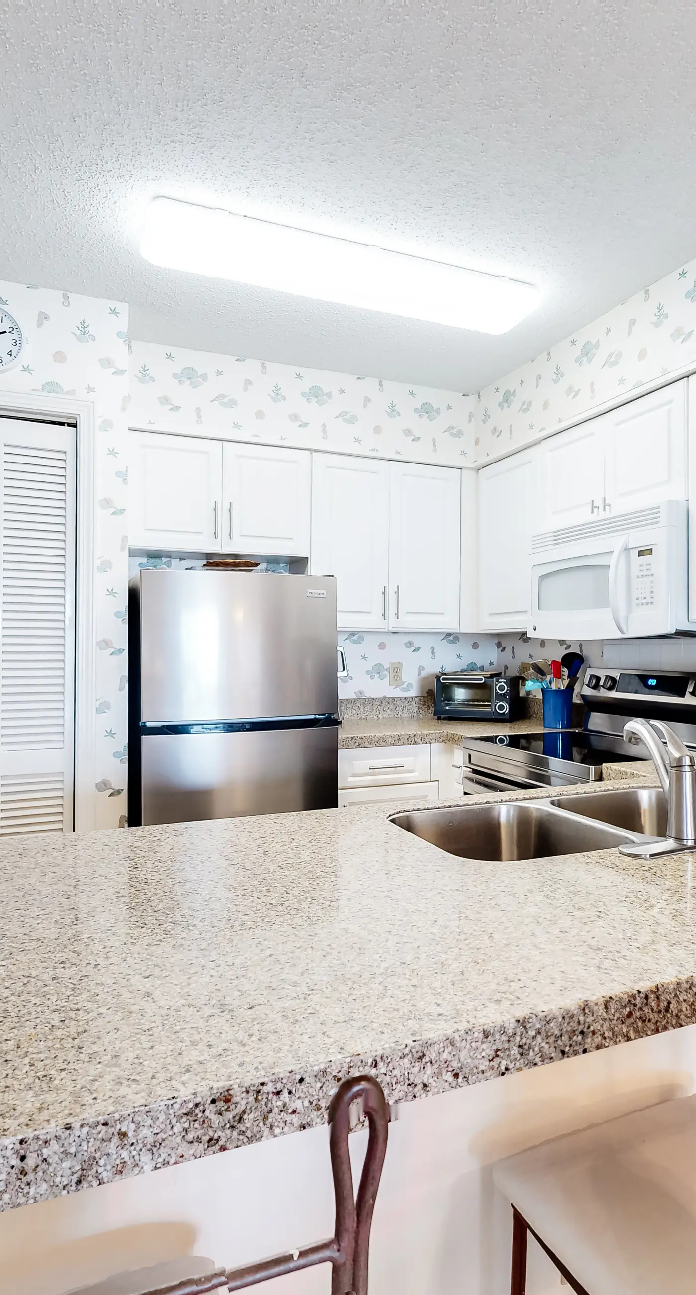 Oceanfront condo with Gulf-view balcony, beach access, pool, WiFi, & central AC