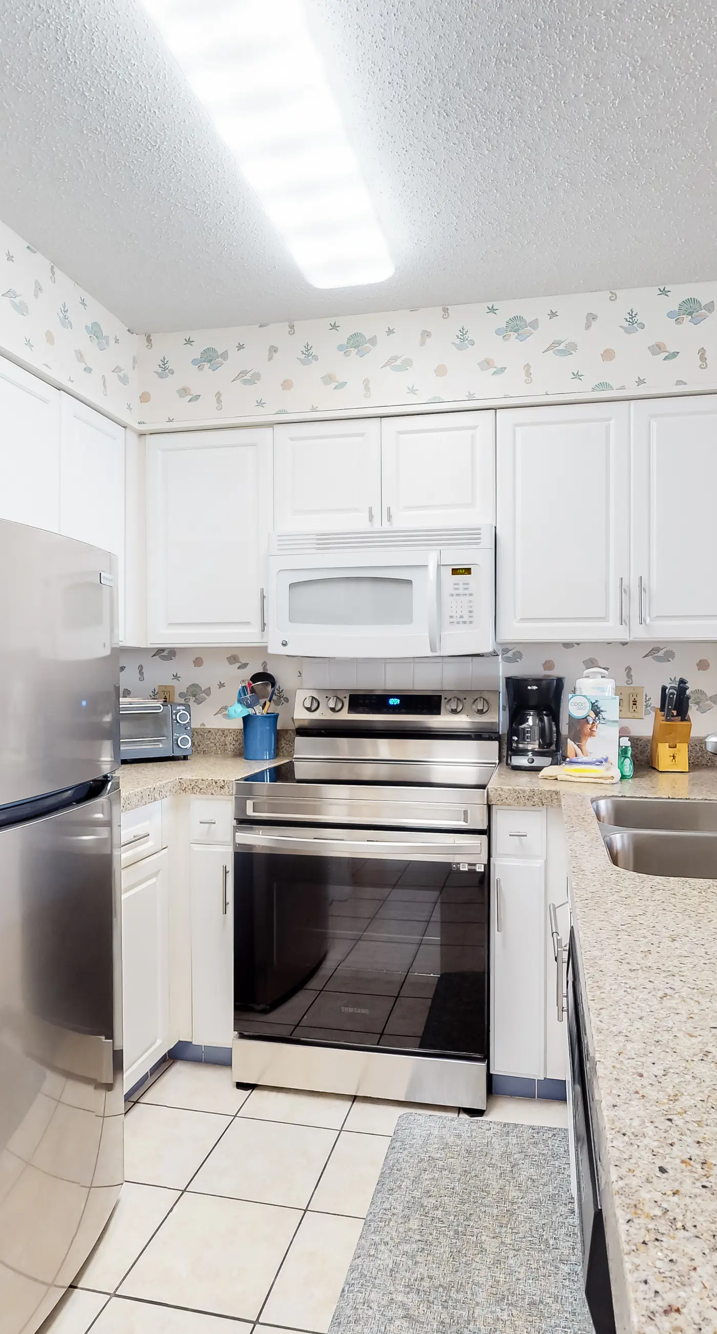 Oceanfront condo with Gulf-view balcony, beach access, pool, WiFi, & central AC