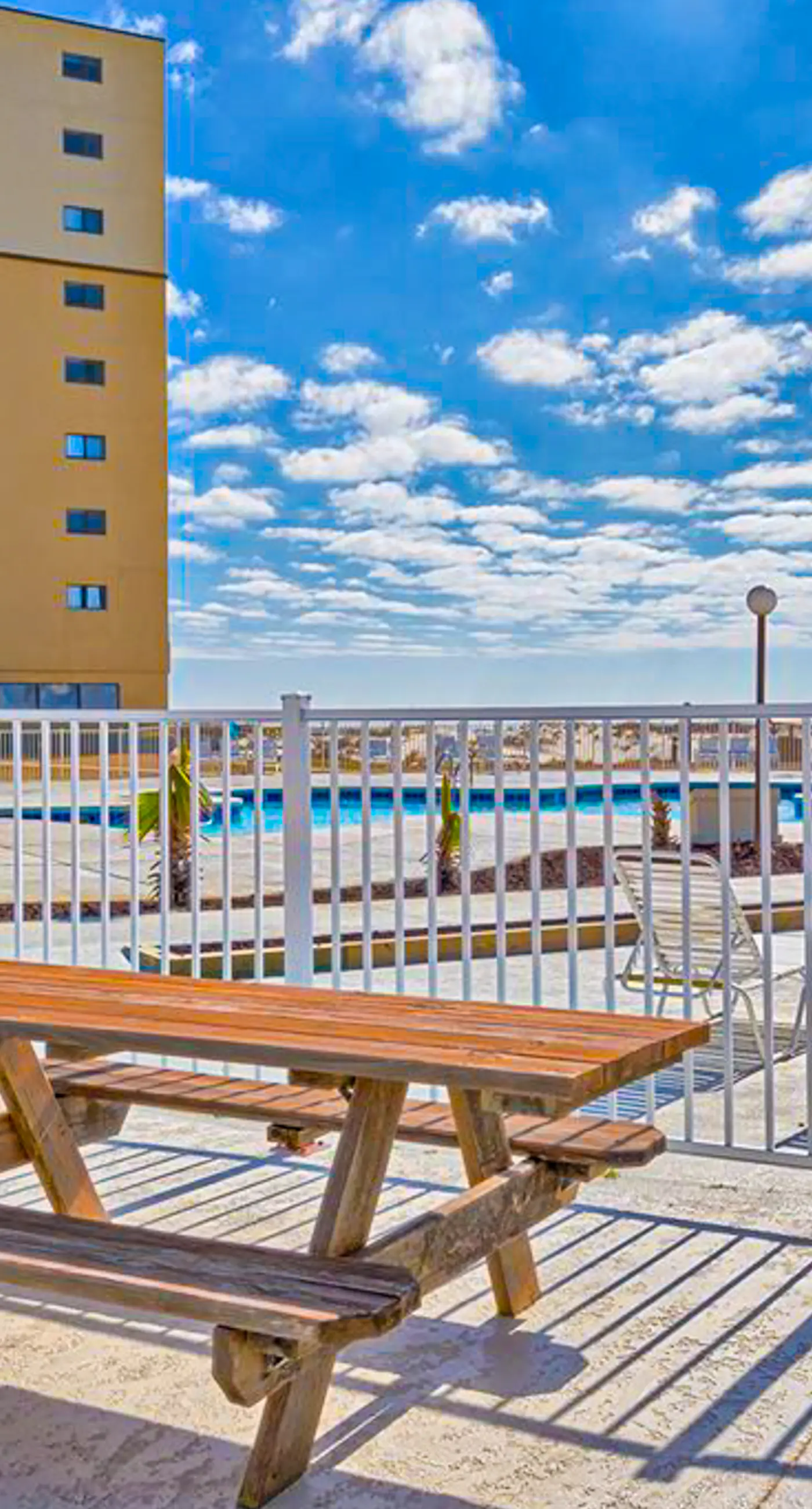 Oceanfront condo with Gulf-view balcony, beach access, pool, WiFi, & central AC