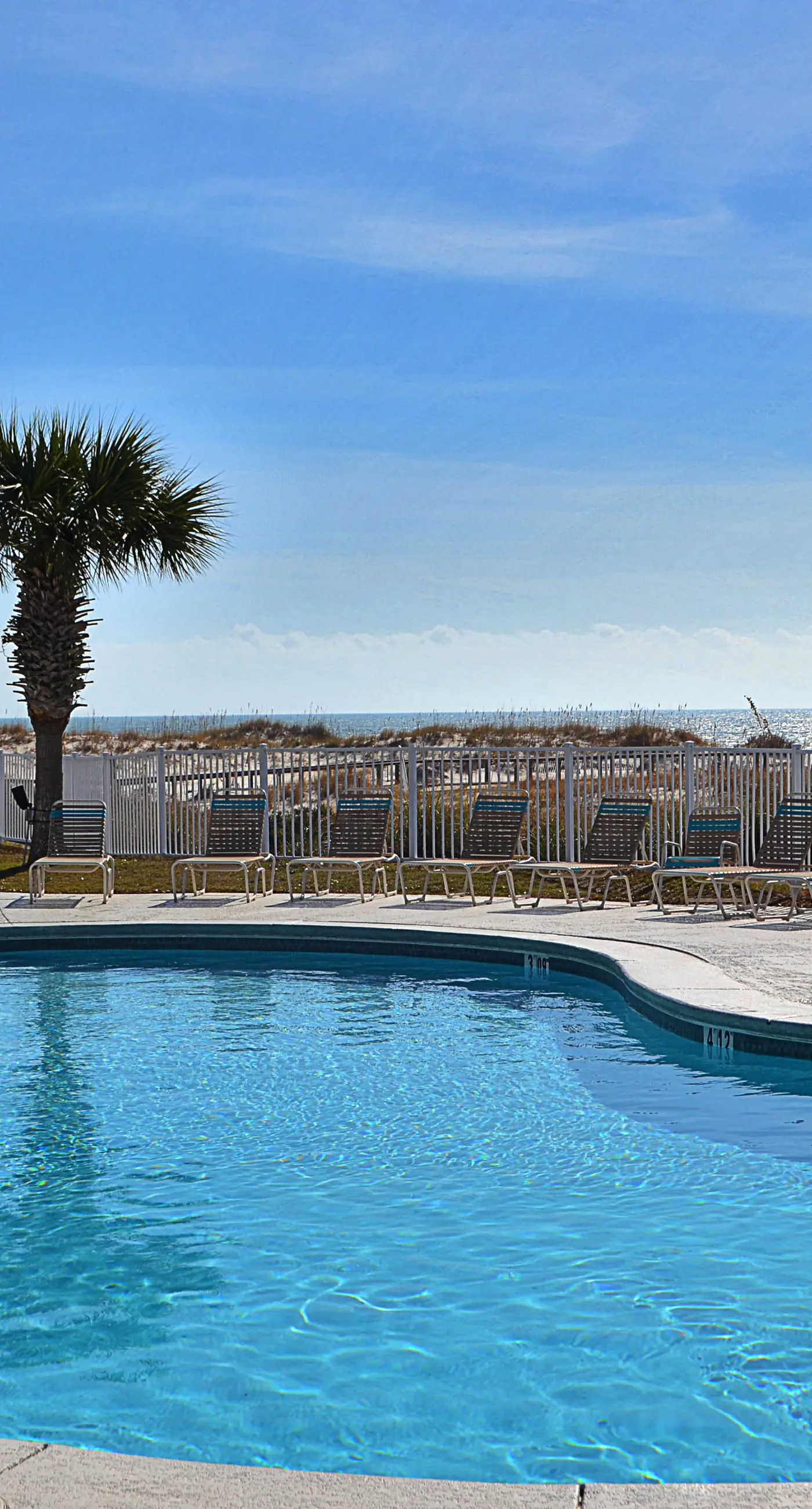 Oceanfront condo with Gulf-view balcony, beach access, pool, WiFi, & central AC