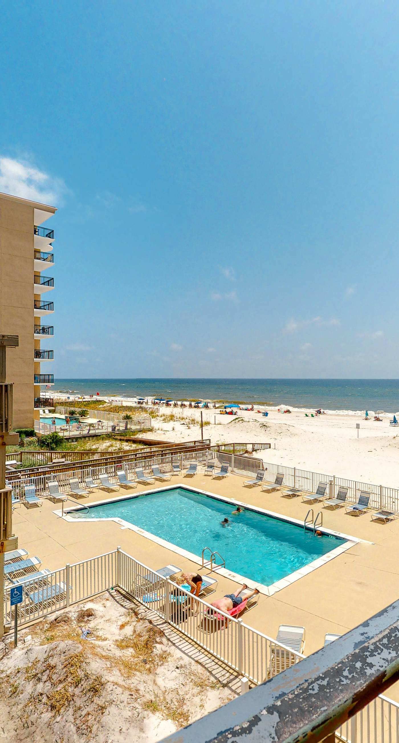 Beachfront condo with balcony overlooking Gulf of Mexico & resort pool