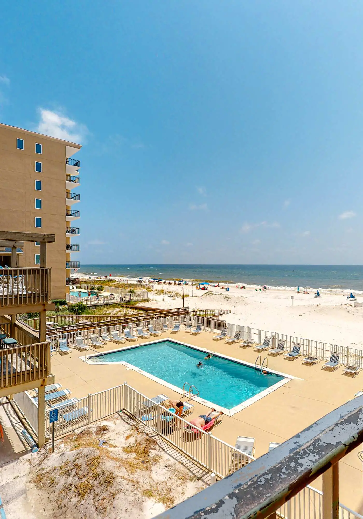 Beachfront condo with balcony overlooking Gulf of Mexico & resort pool