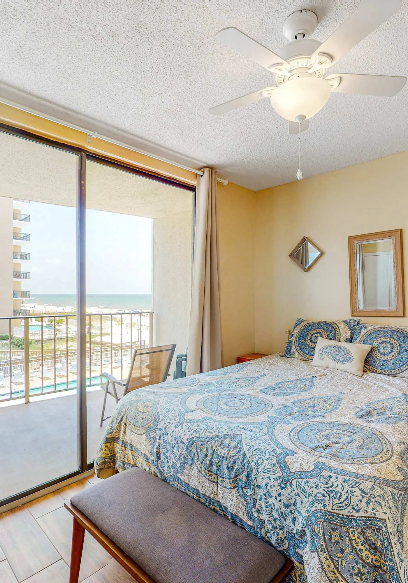Beachfront condo with balcony overlooking Gulf of Mexico & resort pool